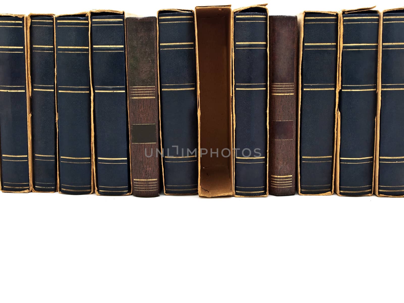 Photo of old book row at white with copyspace  
