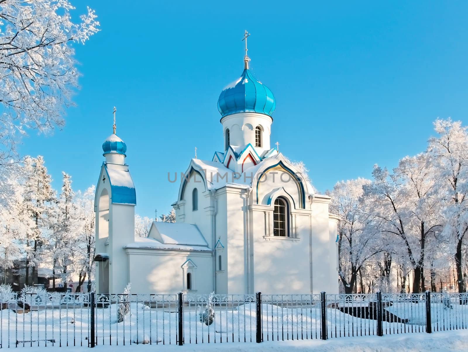 church in winter scenery with white snow and blue sky