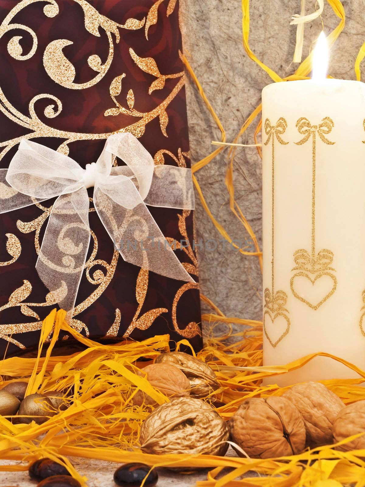  decoration with candle and nuts against beige background 