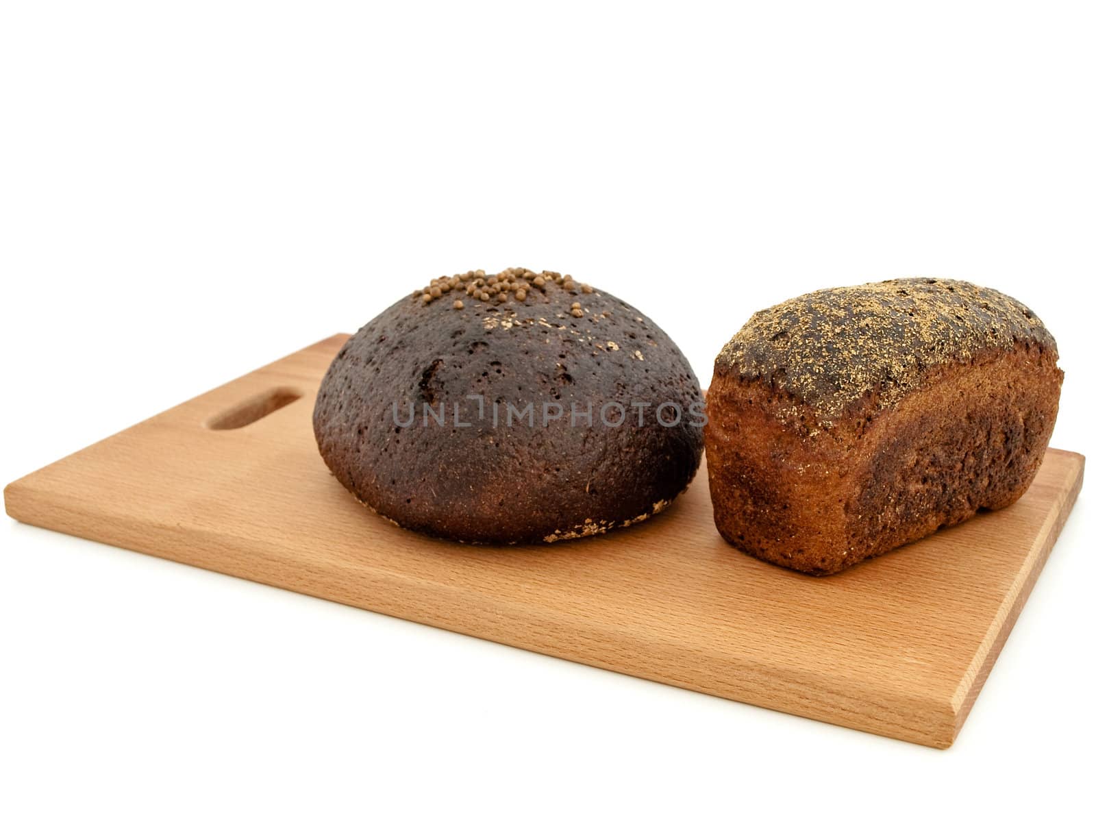 handmade bread at breadboard against white background