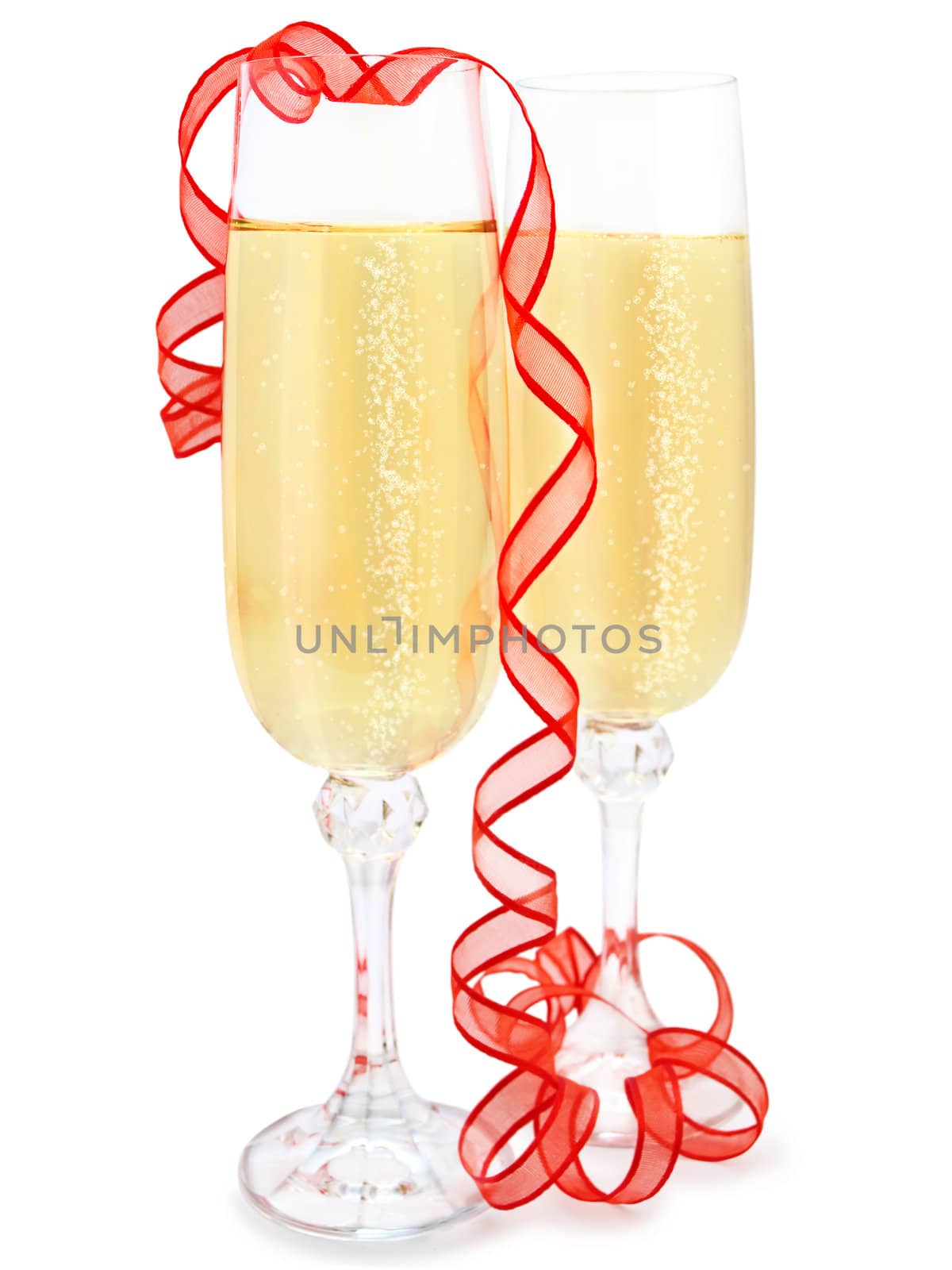 Two elegant champagne glasses with red ribbon against white background 