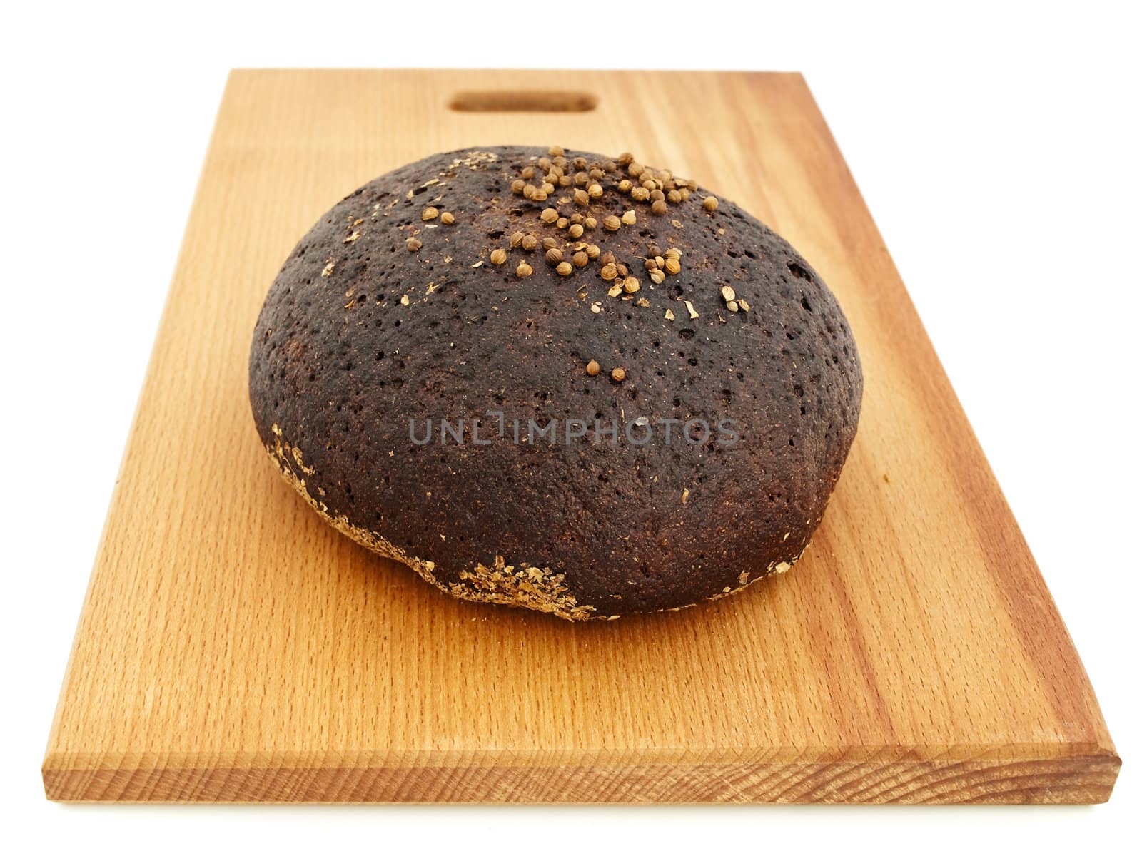 round handmade bread at breadboard against white background