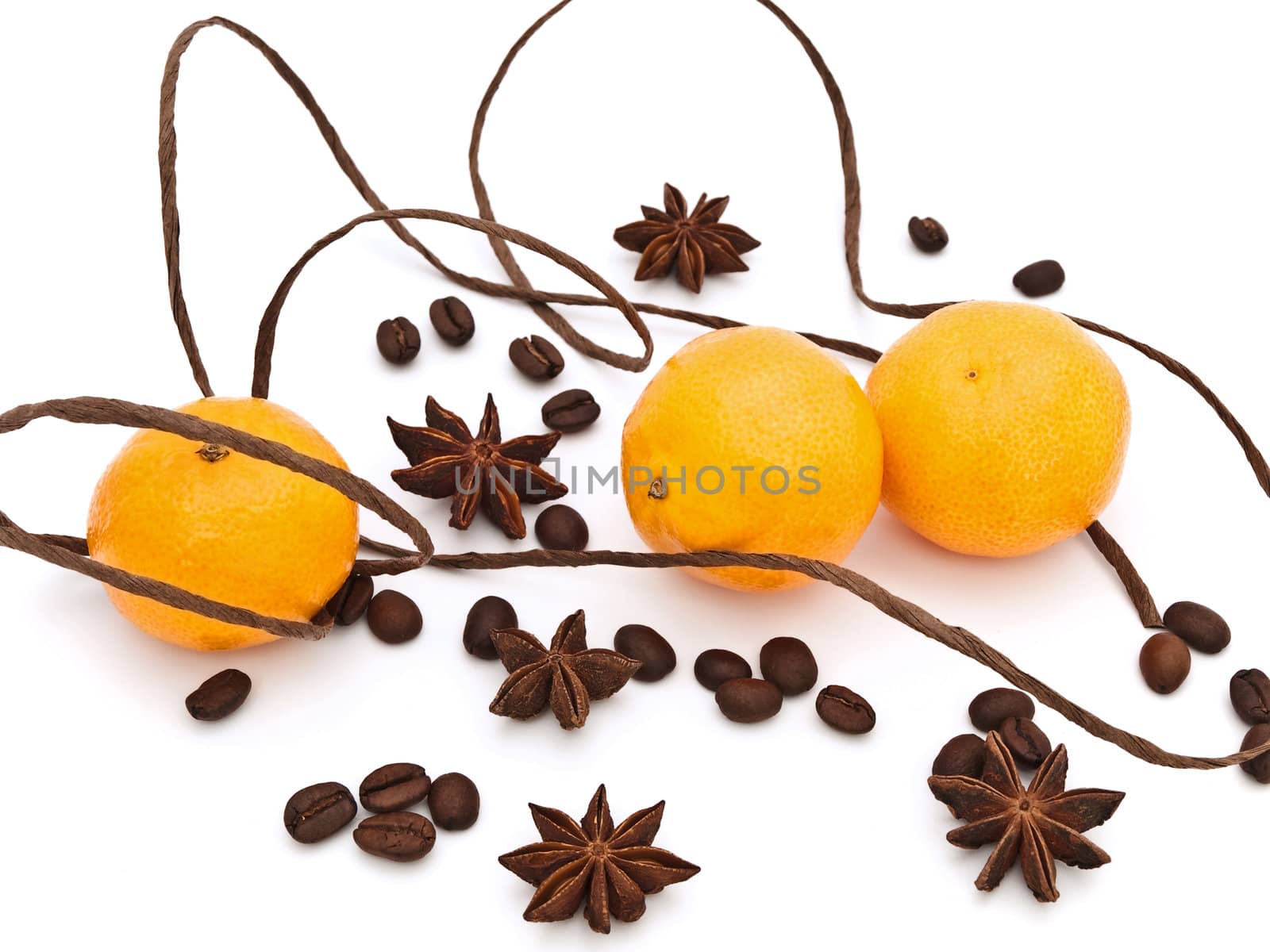  mandarines with decorations of anise stars, coffie and cord against white background 
