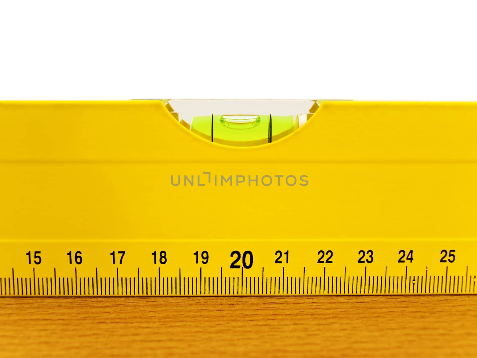 yellow level on the brown wooden plank
