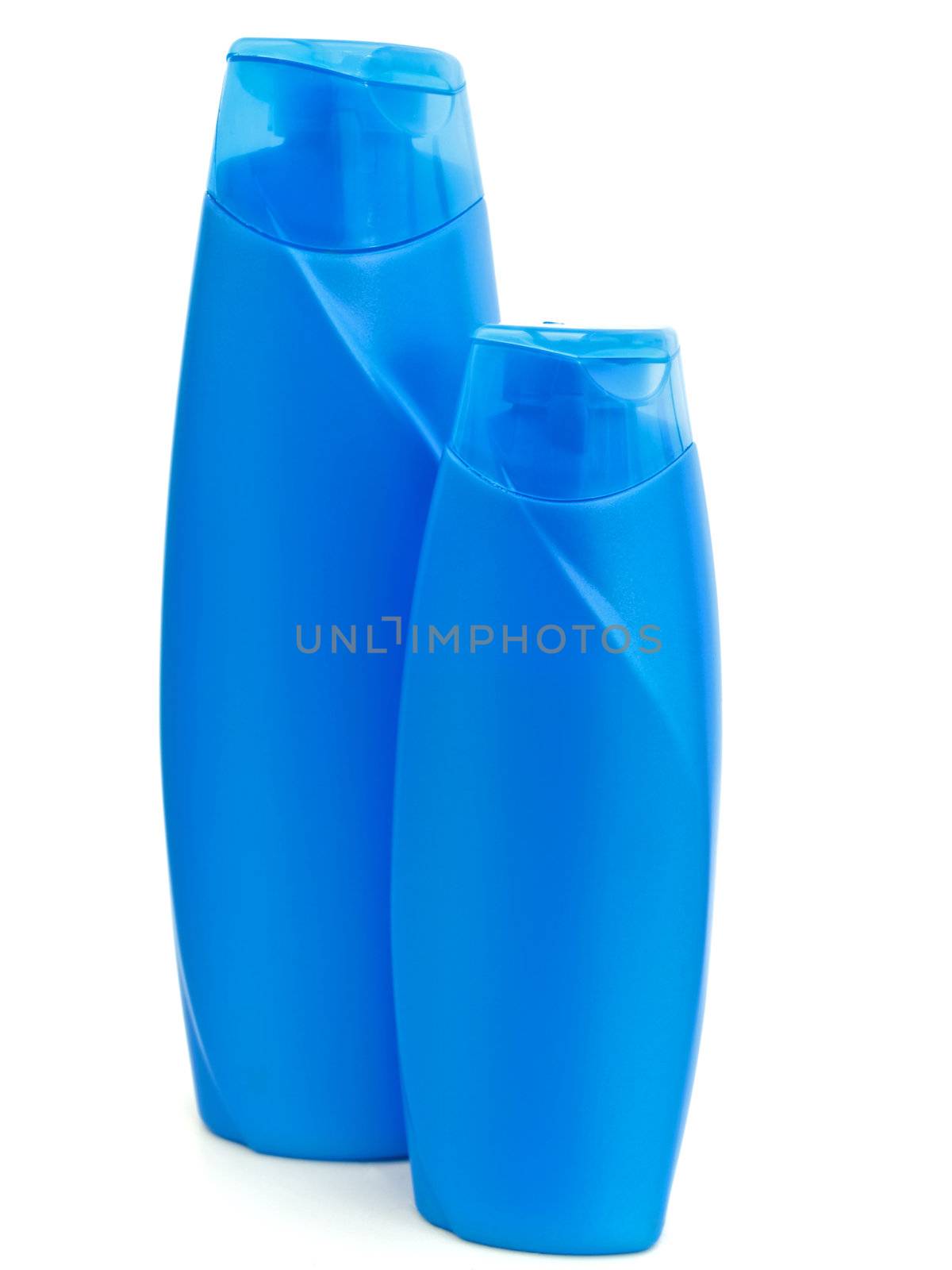 two plastic blue bottles of shampoo over white