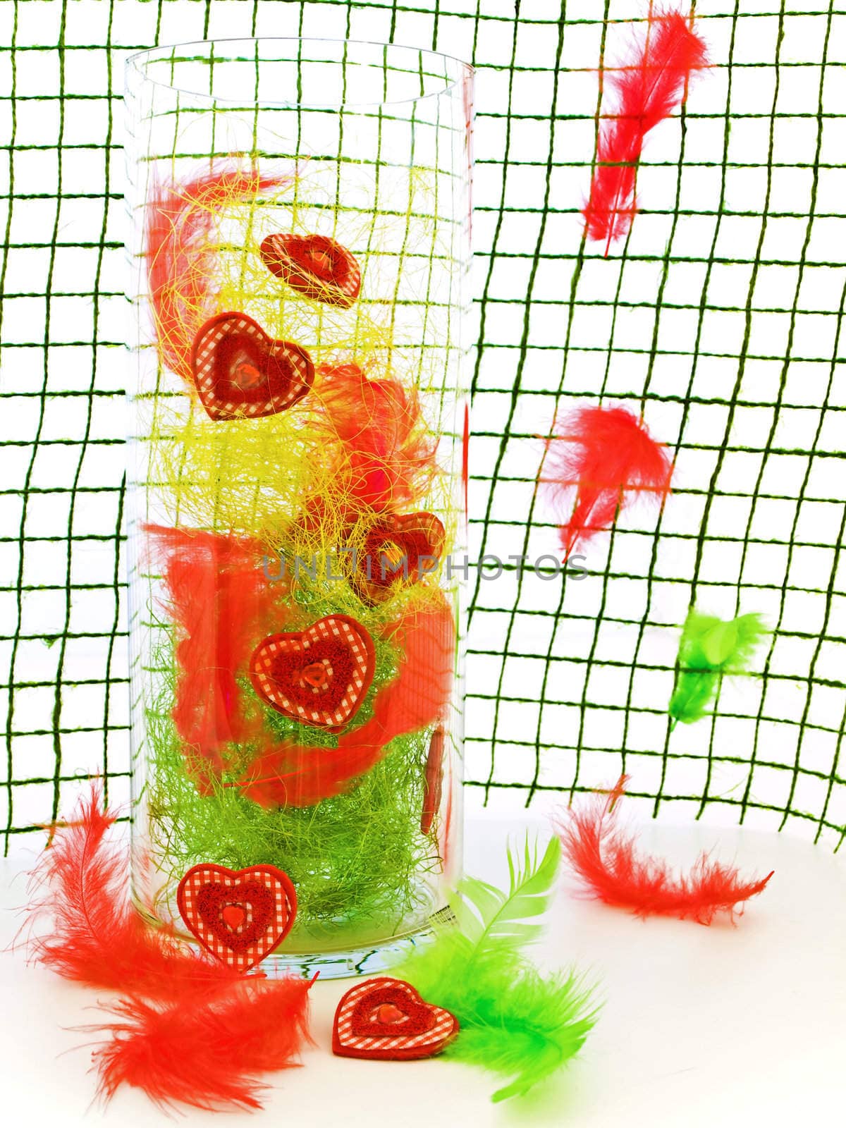decorative hearts in glass vase against decorated background