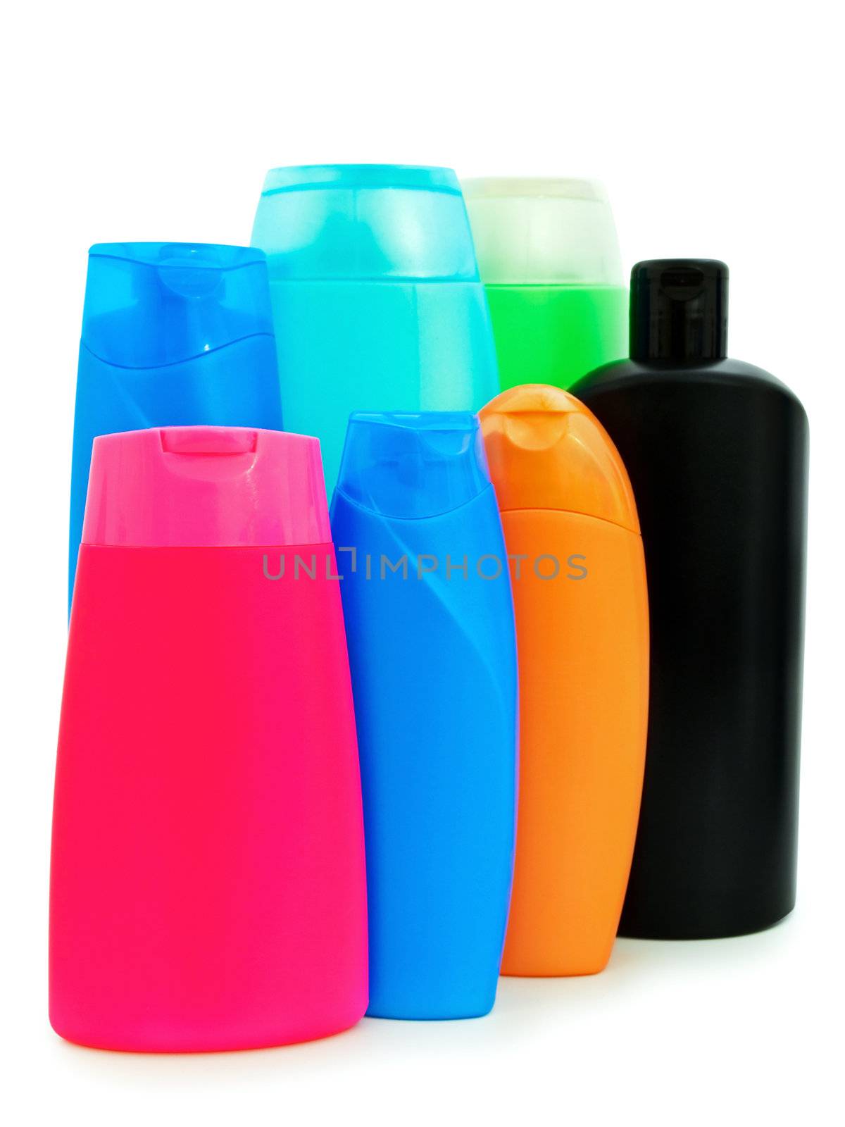 different toiletries  plastic bottles over white background