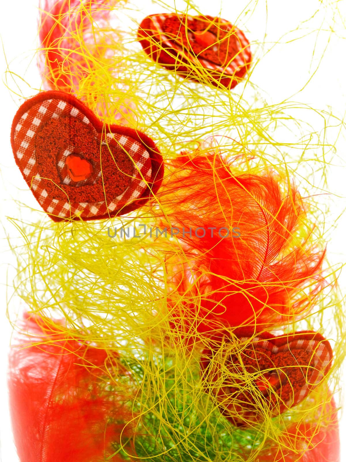 decorative hearts in glass vase against white