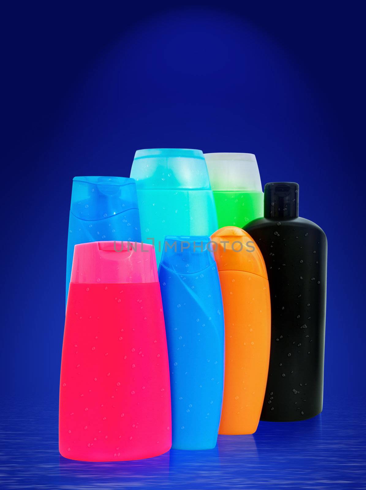 different toiletries plastic bottles over the blue