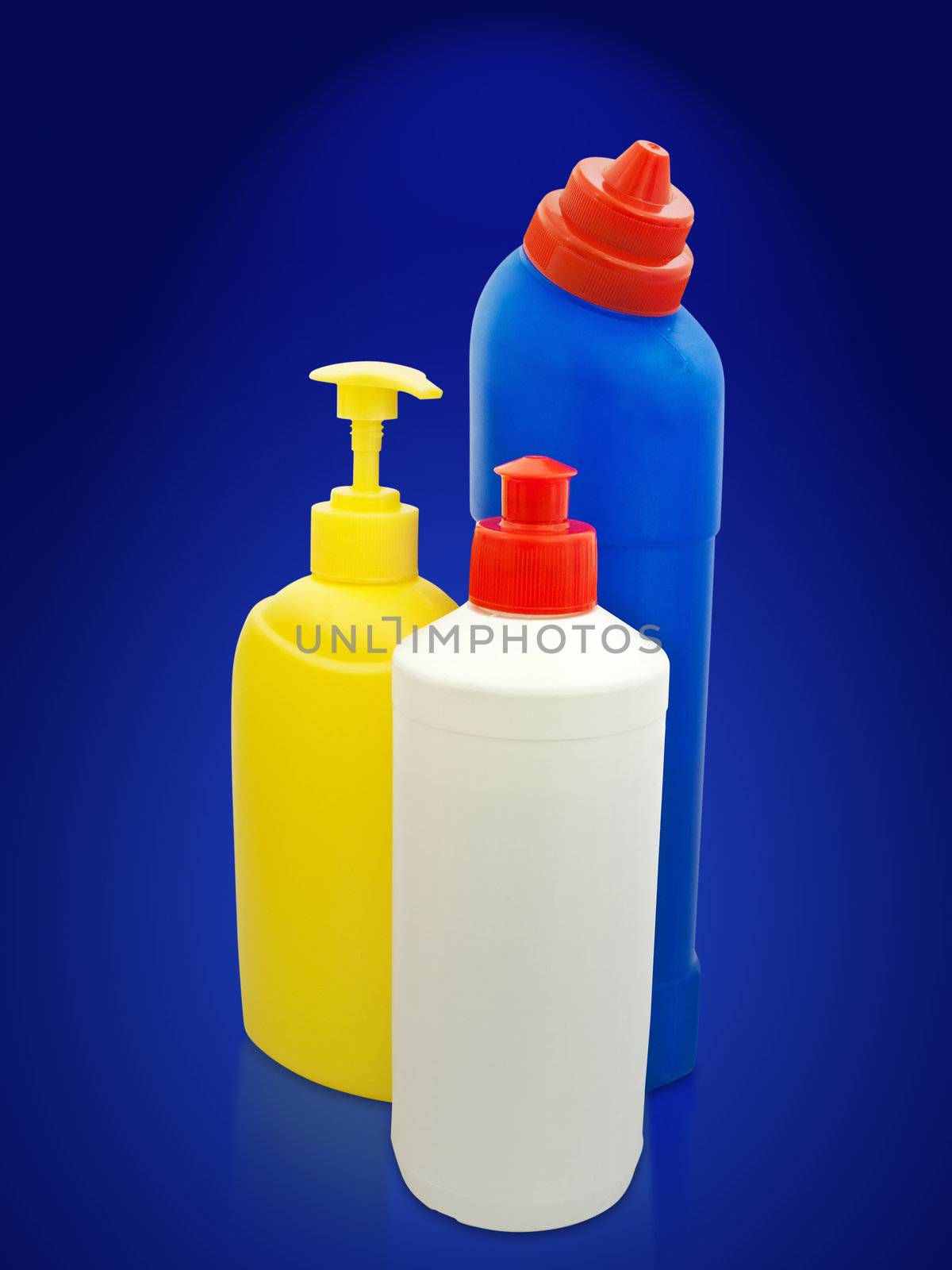 different toiletries plastic bottles over the blue