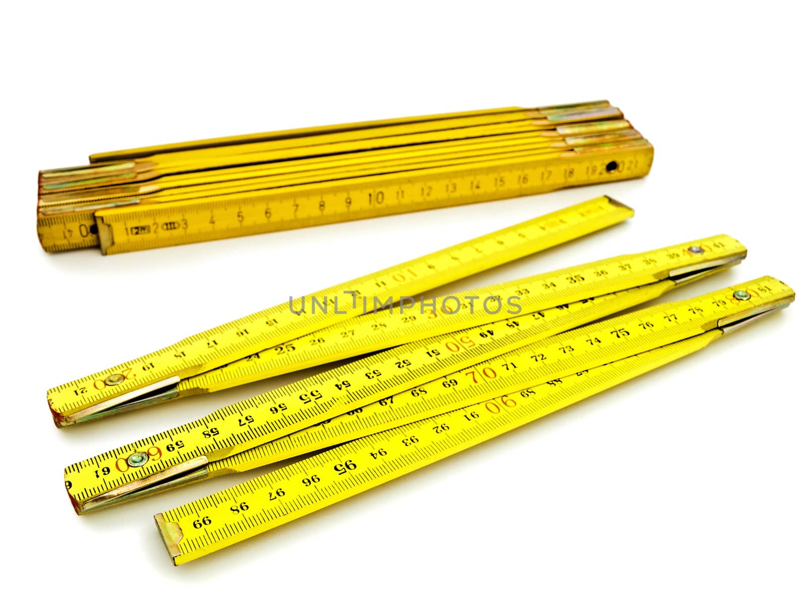 Two yellow wooden meters over the white background  
