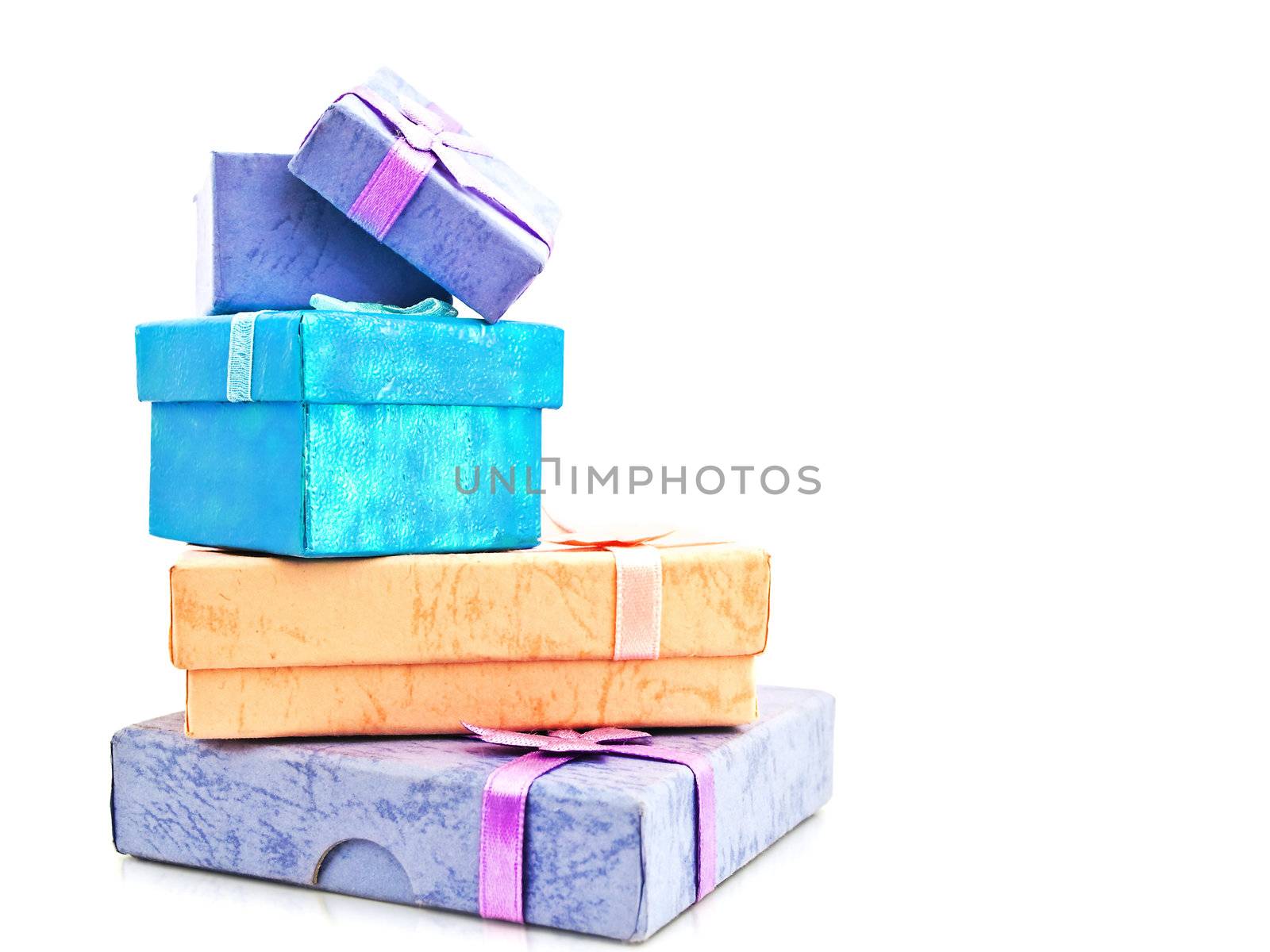 Multicolored gift boxes stack with bows against white background