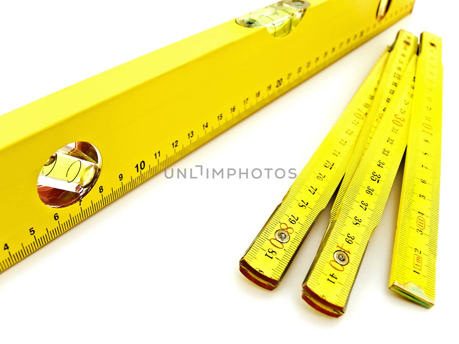 yellow wooden meter and level over the white background  