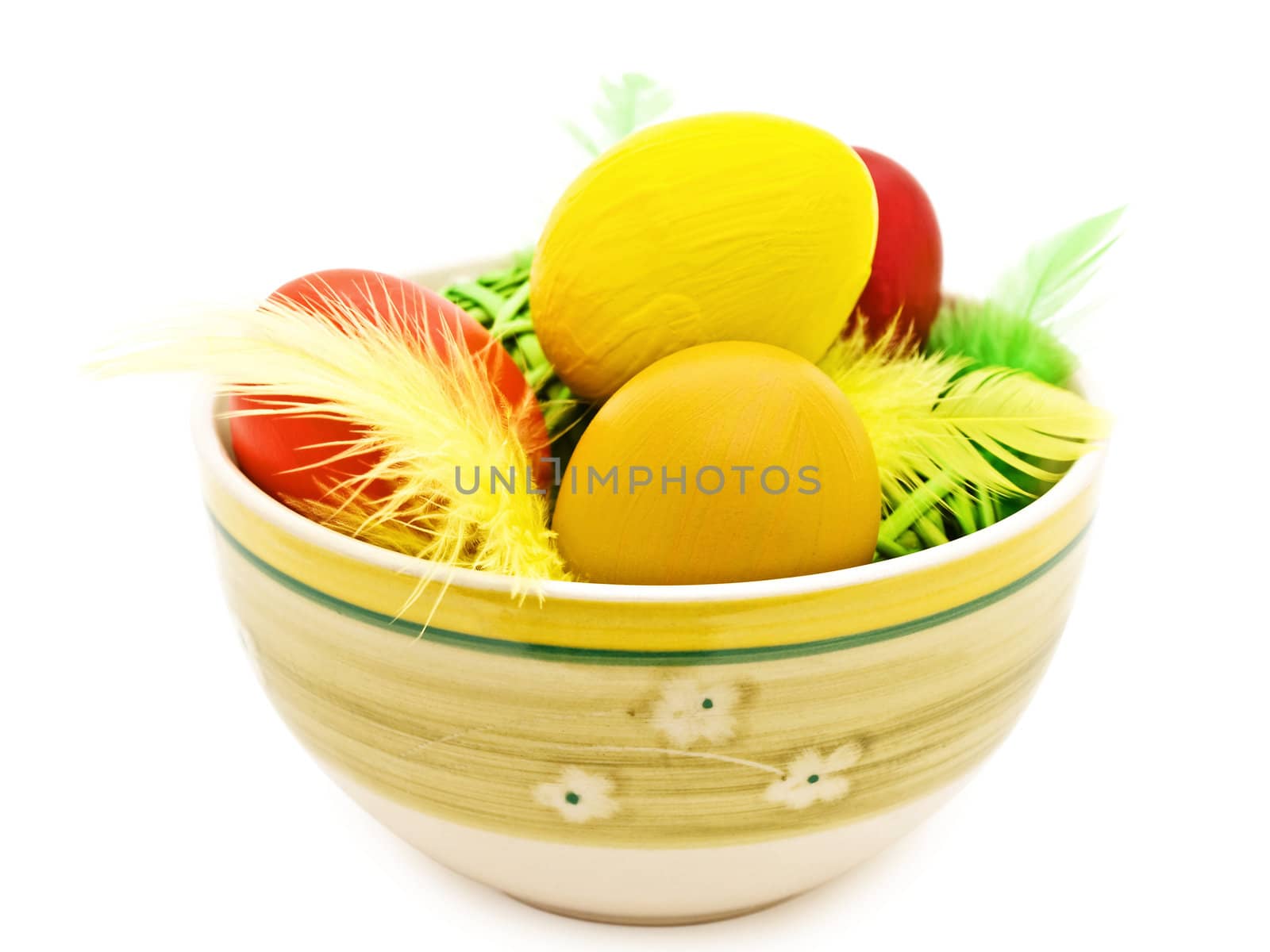 different easter eggs and feathers in the bowl 