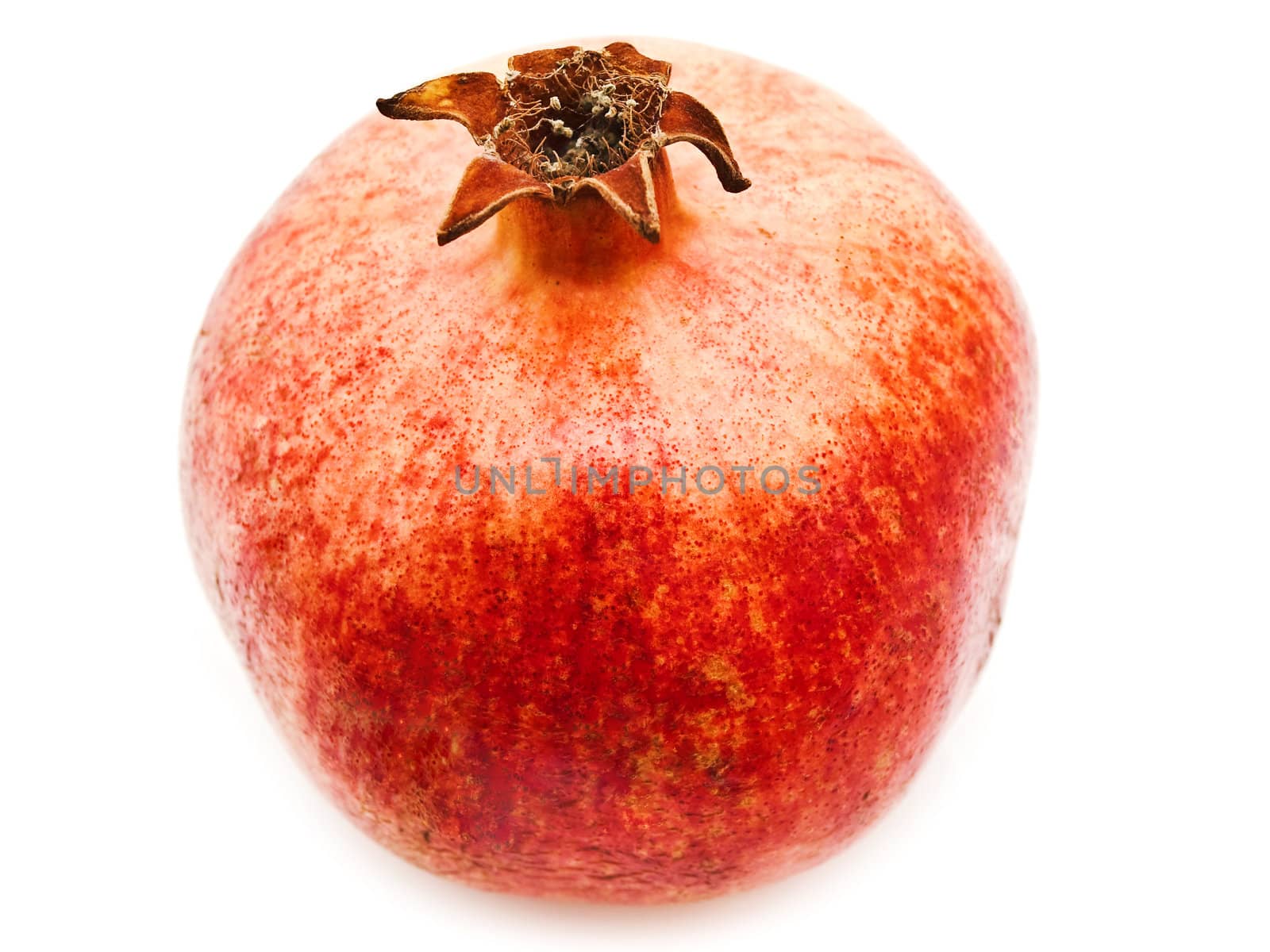 Single red pomegranate over the white background
