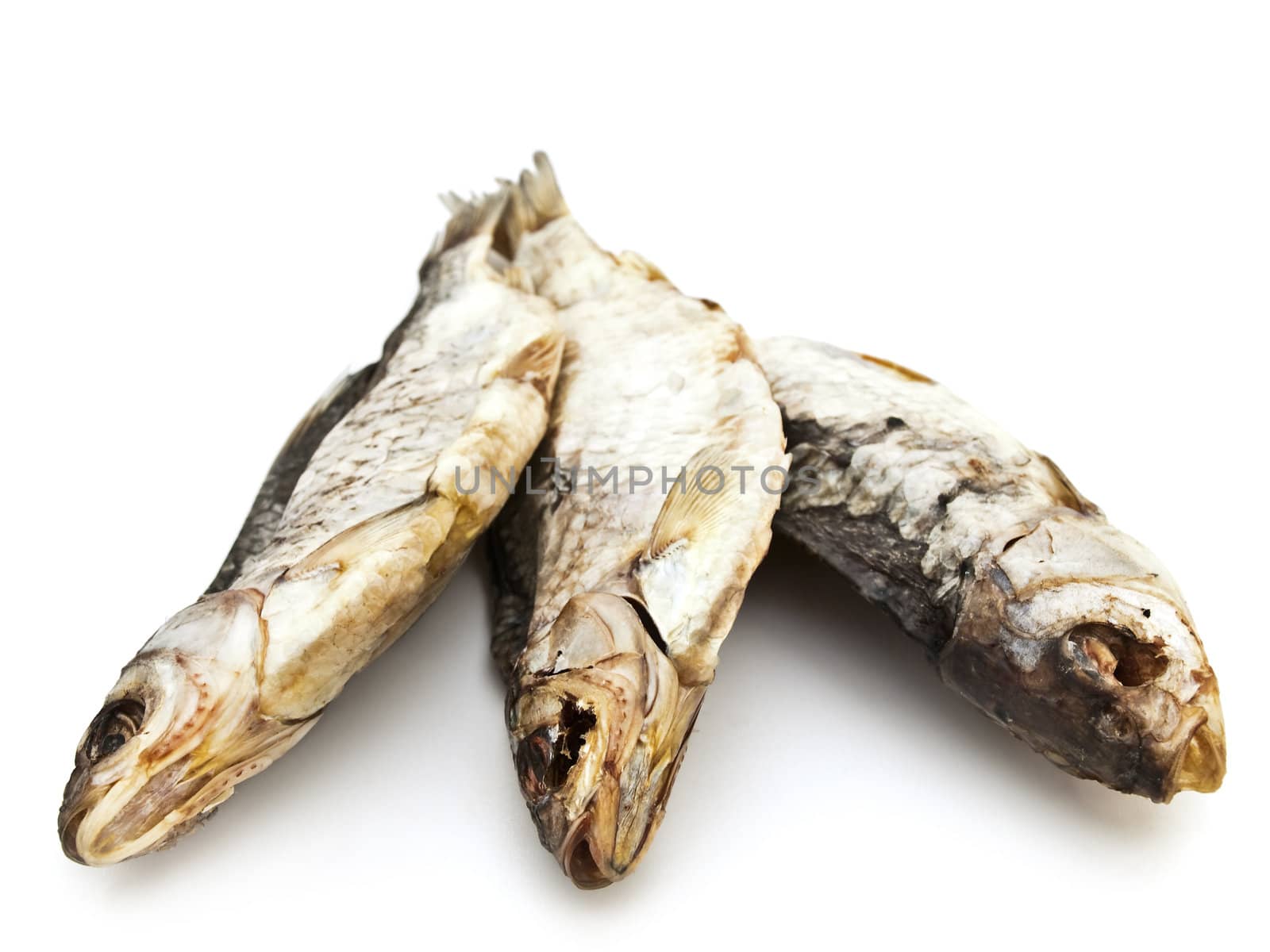 three dried fishes over the white background
