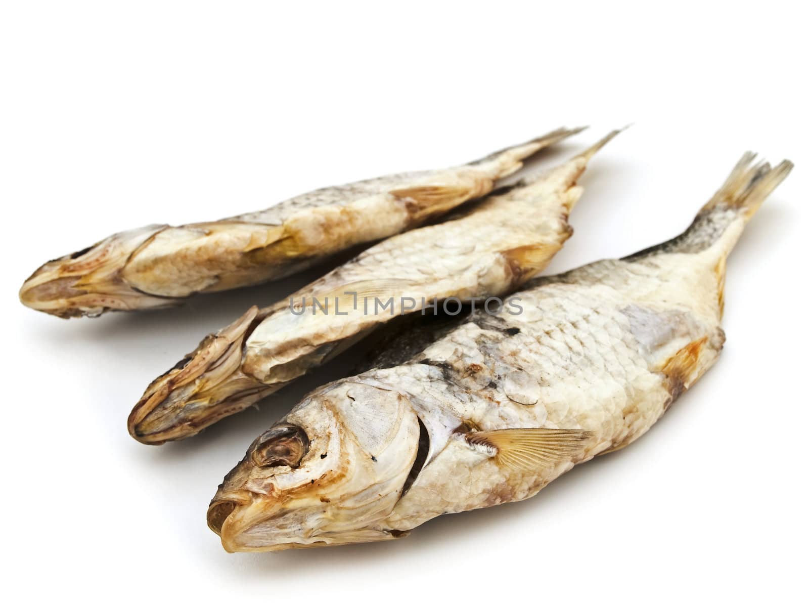 three dried fishes over the white background