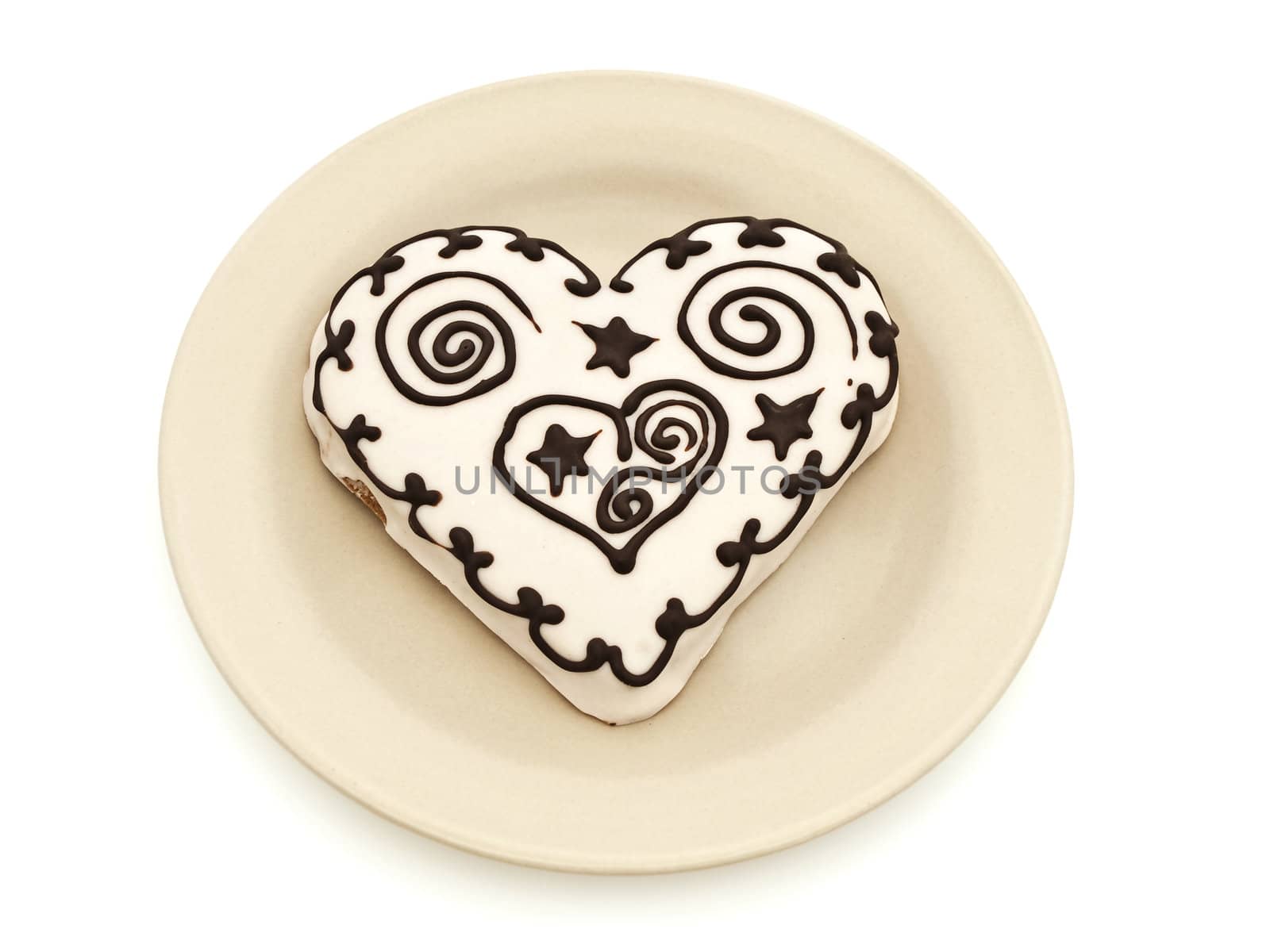 Photo of spice cake in heart shape in plate against white background