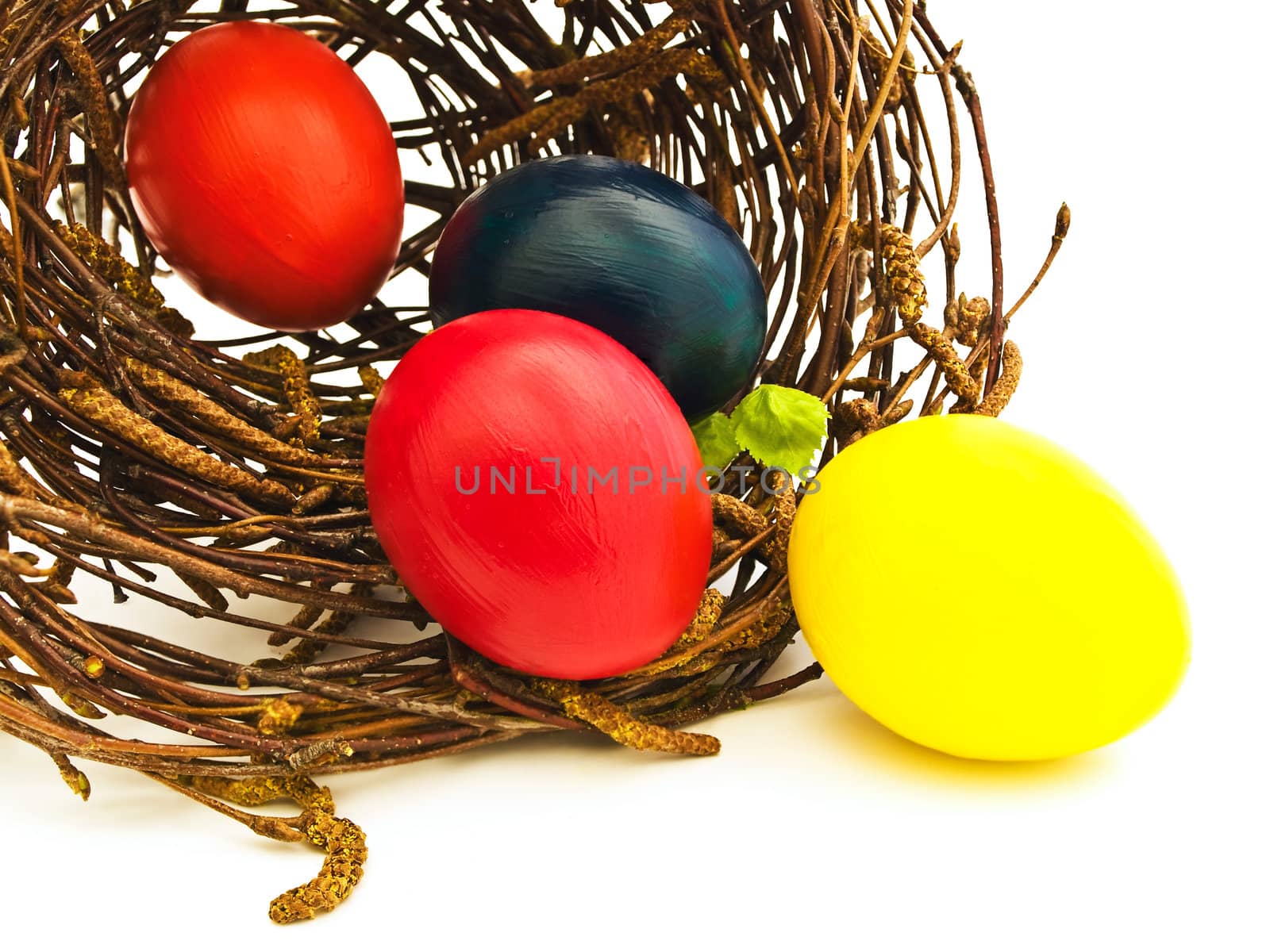 easter nest with multicolored eggs against white