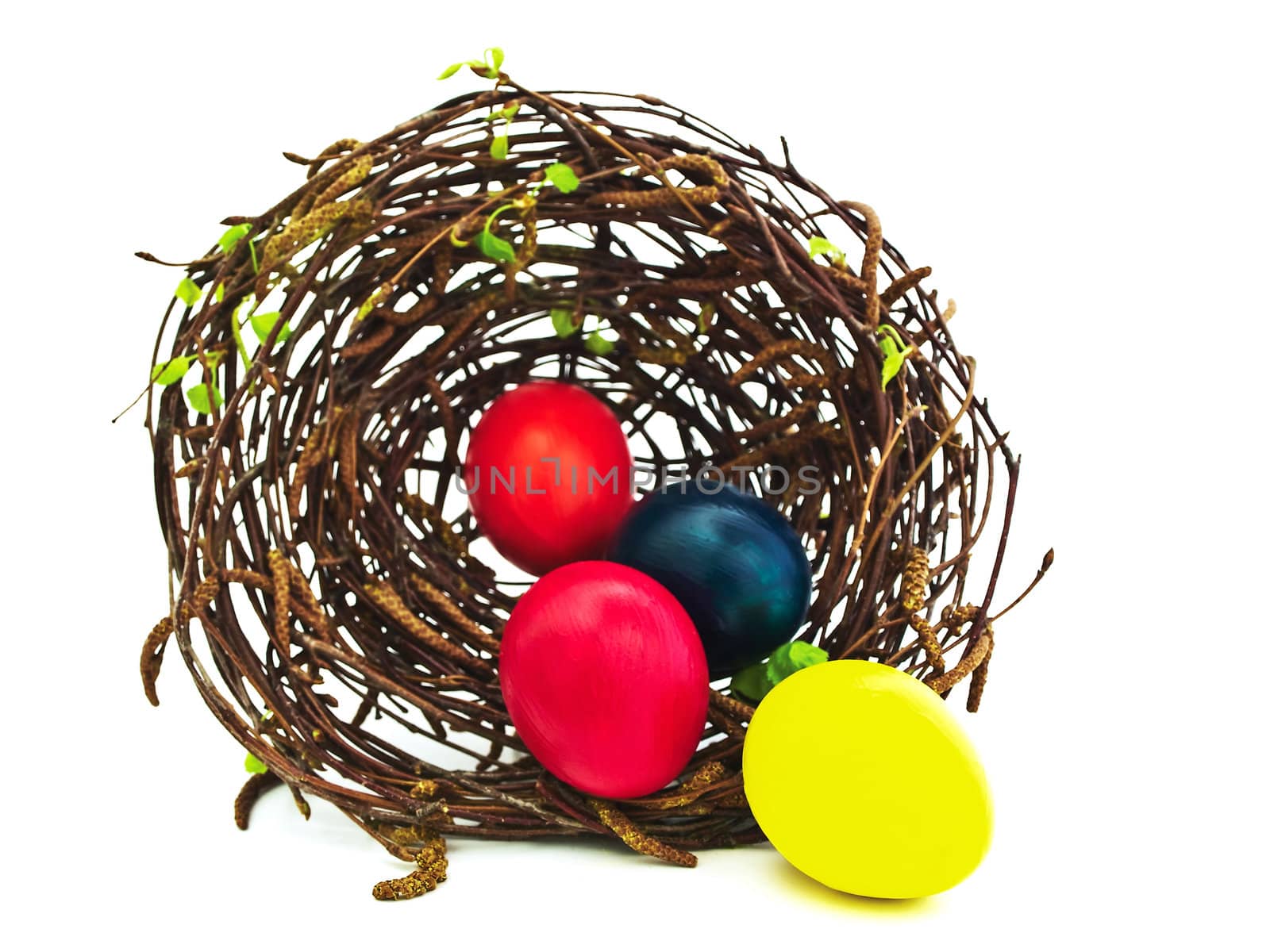 easter nest with multicolored eggs against white