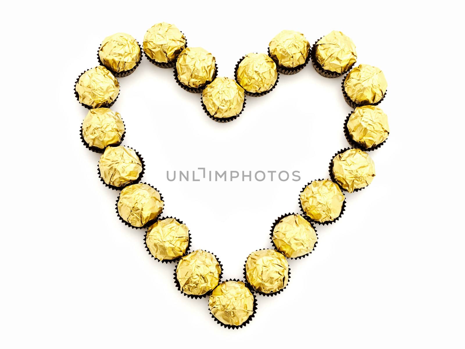 heart shape from sweets in golden candy wrapper 