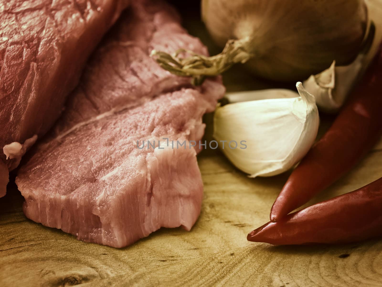 pieces of meat with spices on hardboard