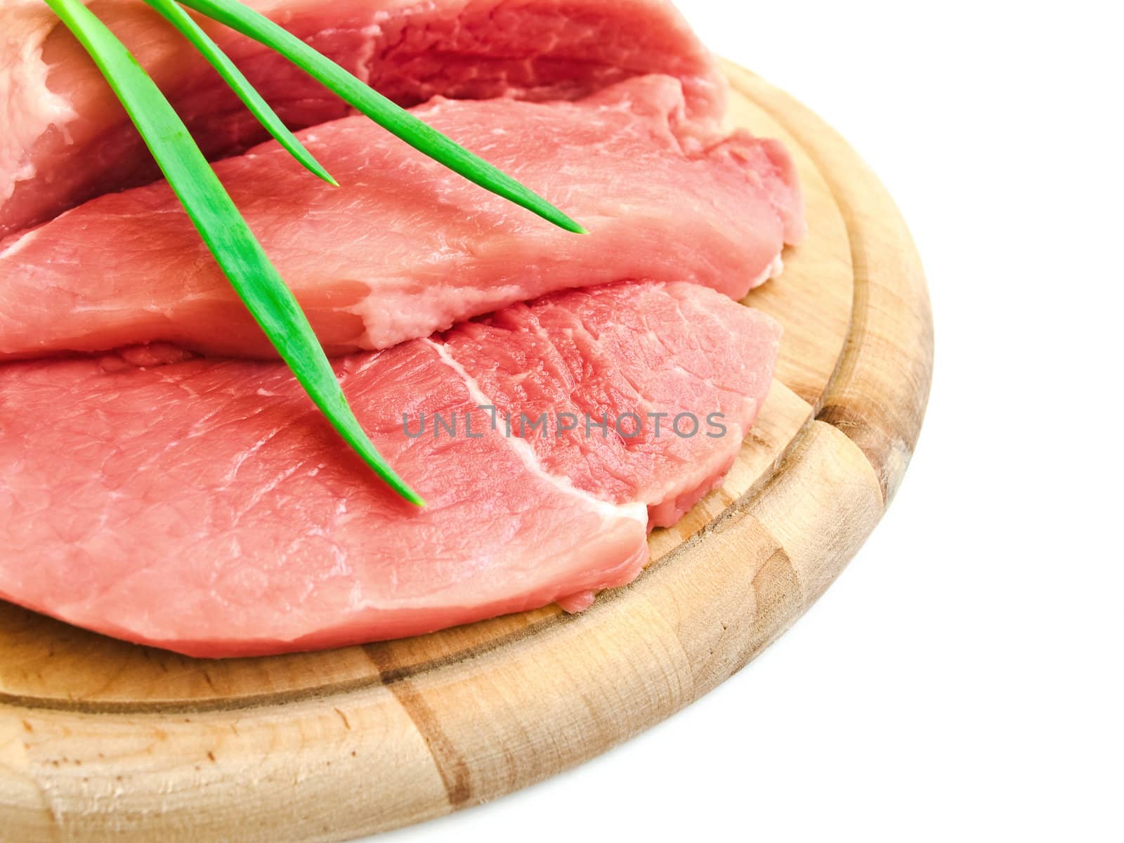 piecies of meat with spring onion on the hardboard 
