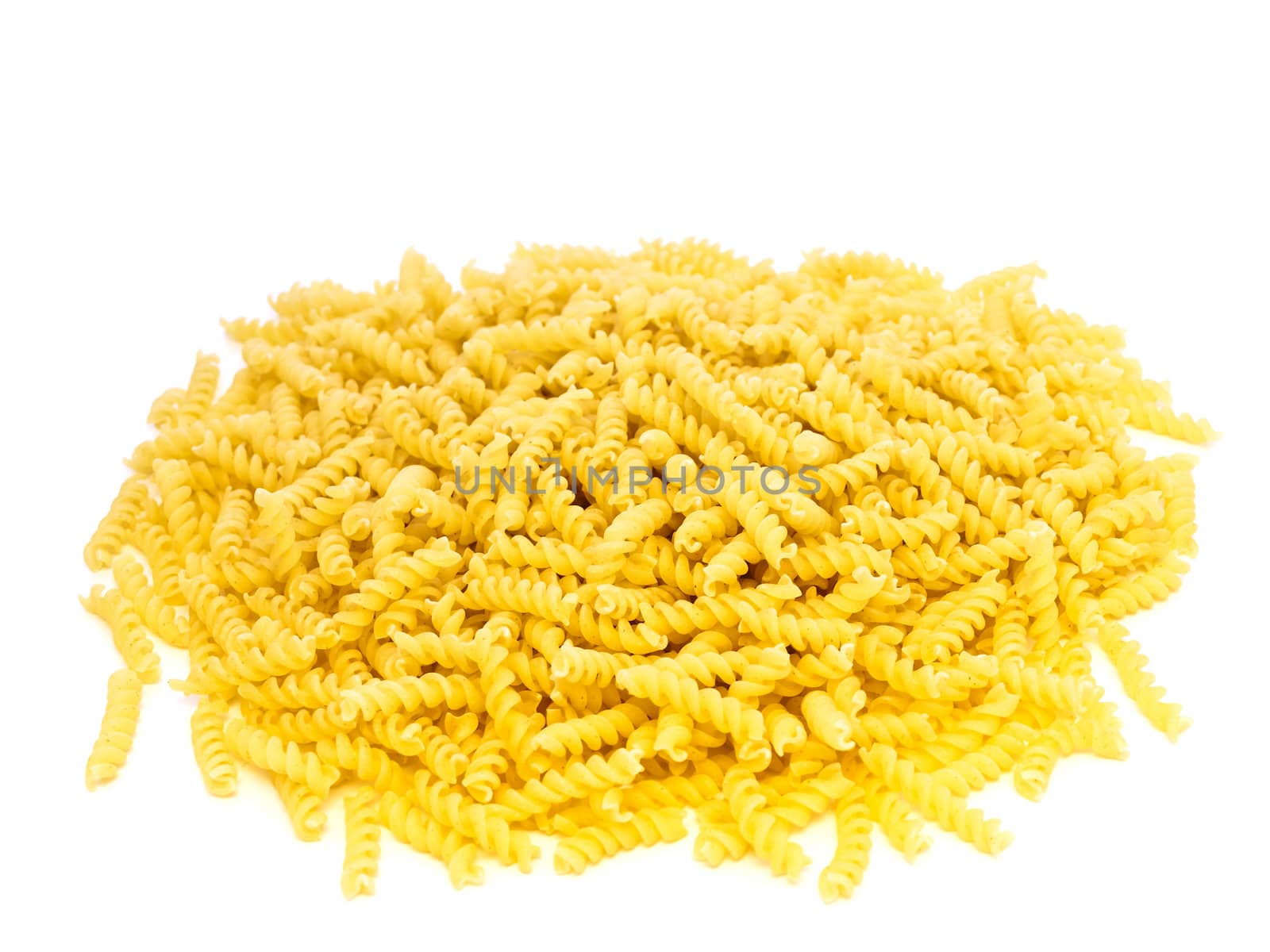 yellow spiral pasta over the white background