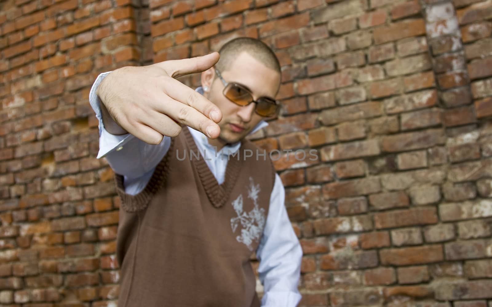 rapper boy wearing elegant clothes, showing sign