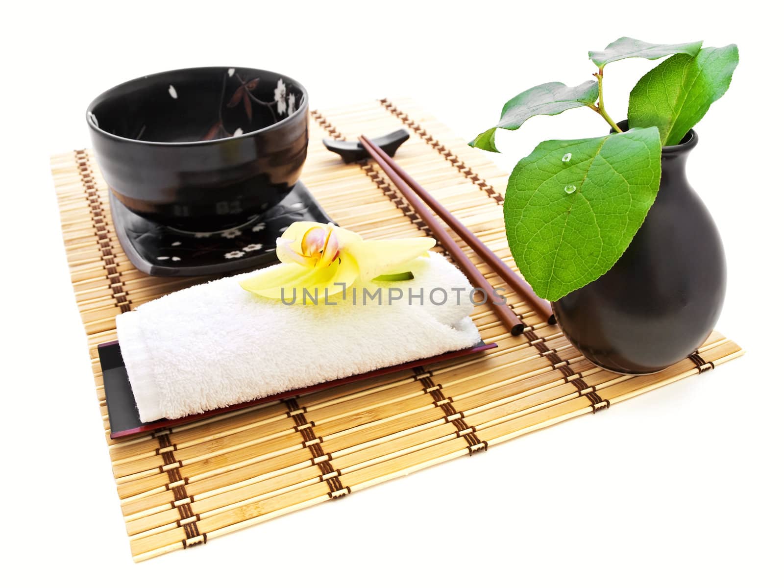 oriental style table serving with orchid and green leaves