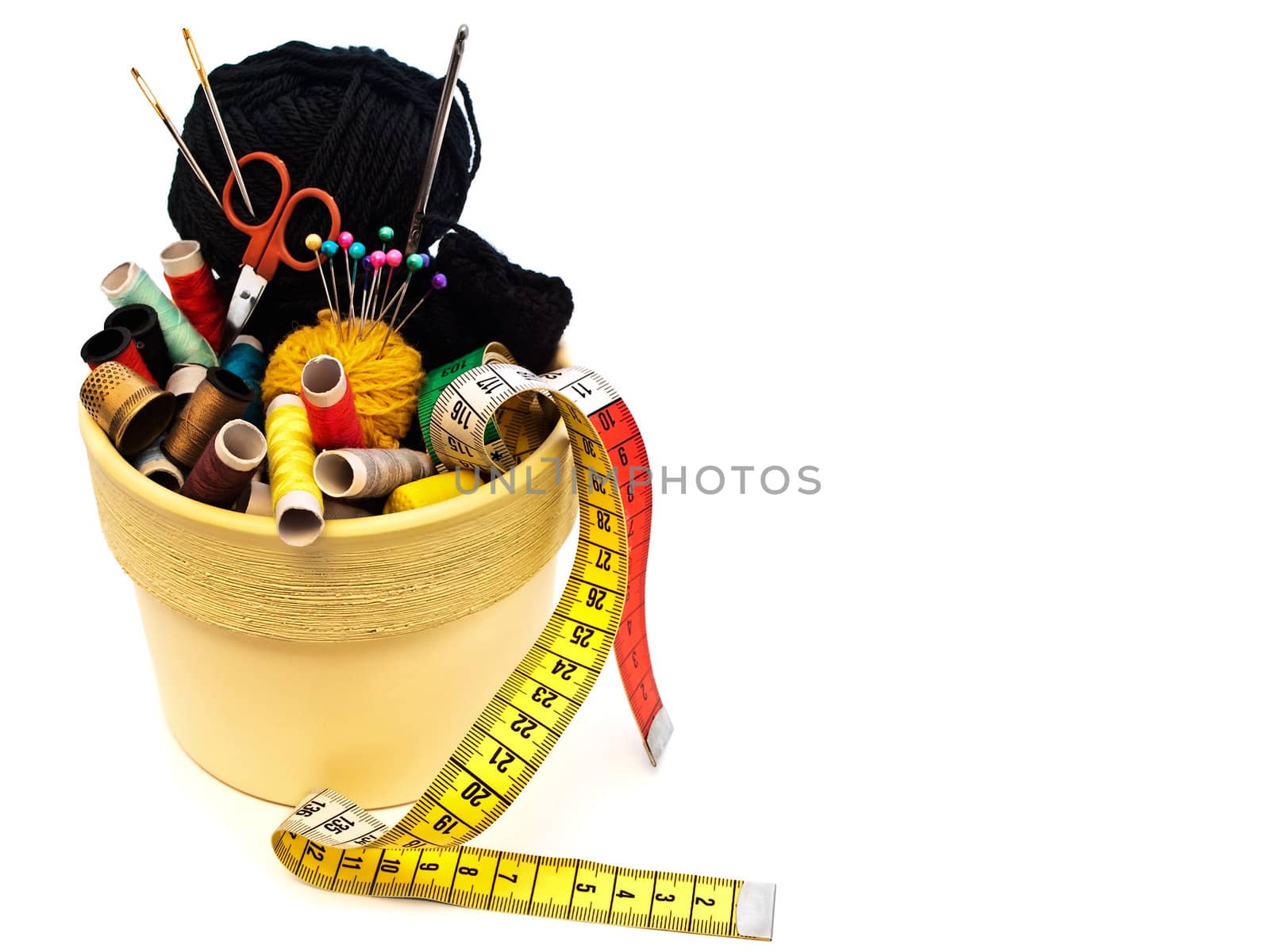 different knitting items in the pot over the white background