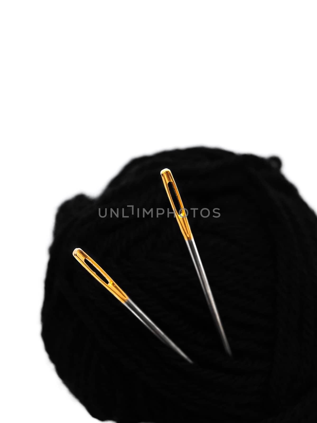 two needles with golden needle's eye in the black clew
