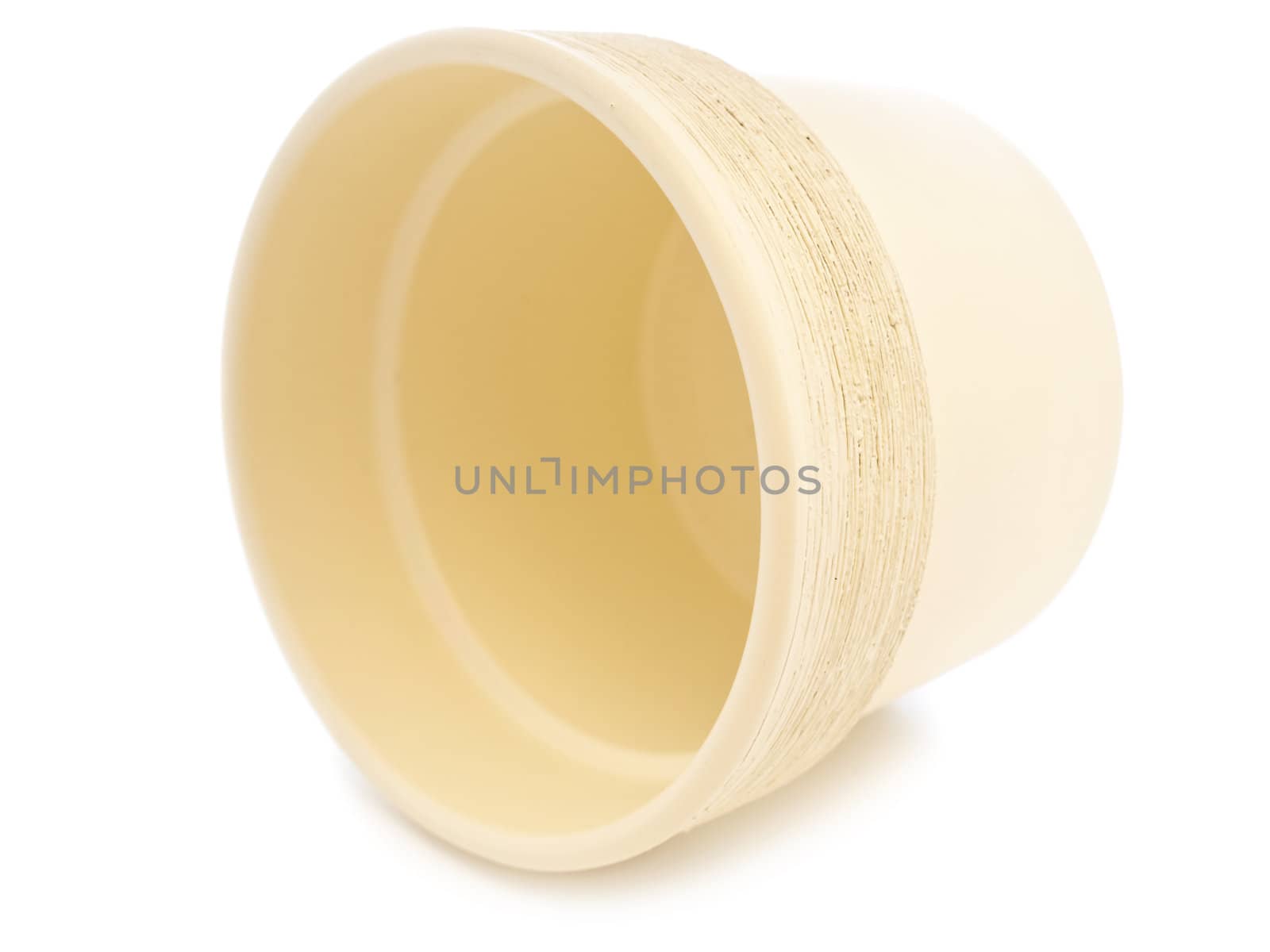 empty beige flowerpot over the black background