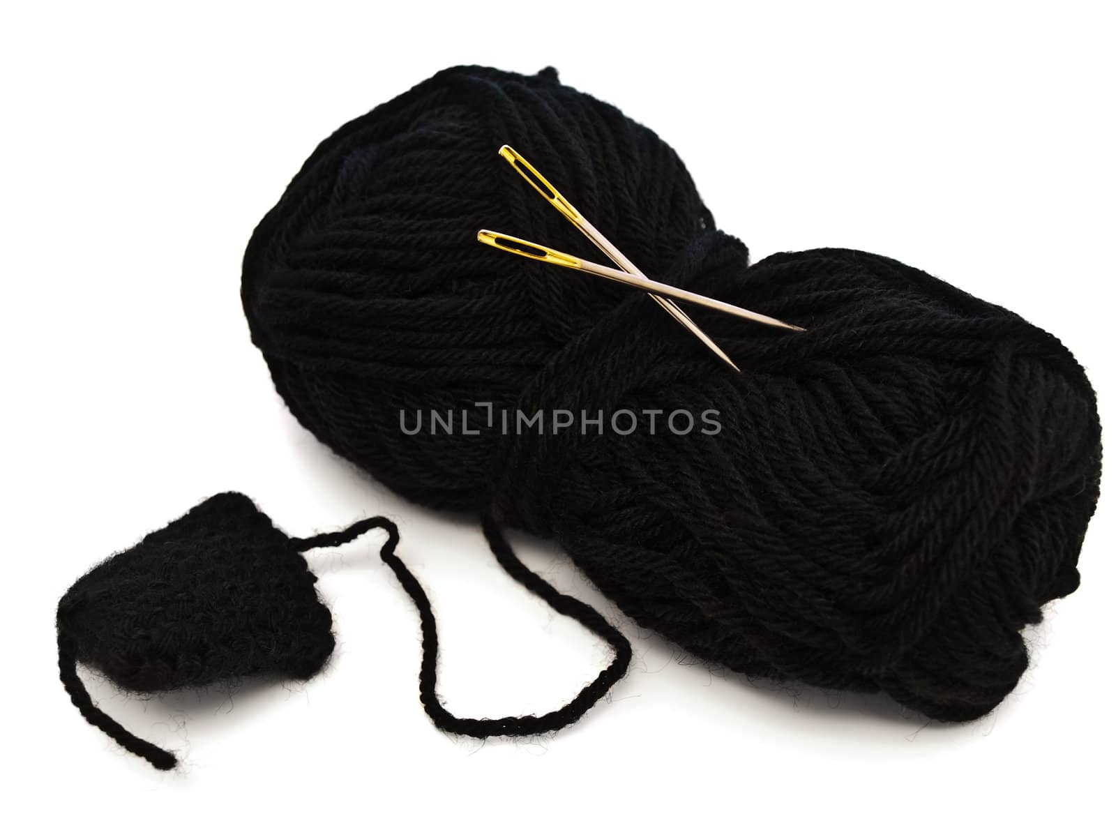 two needles with golden needle's eye in the black clew