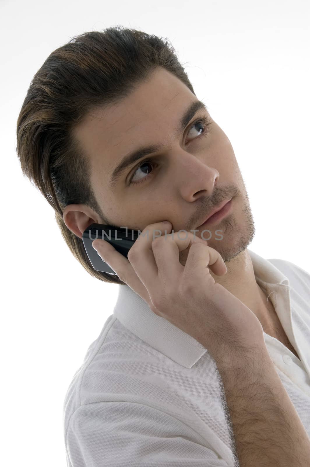 young man talking on the cellphone on an isolated white backgound