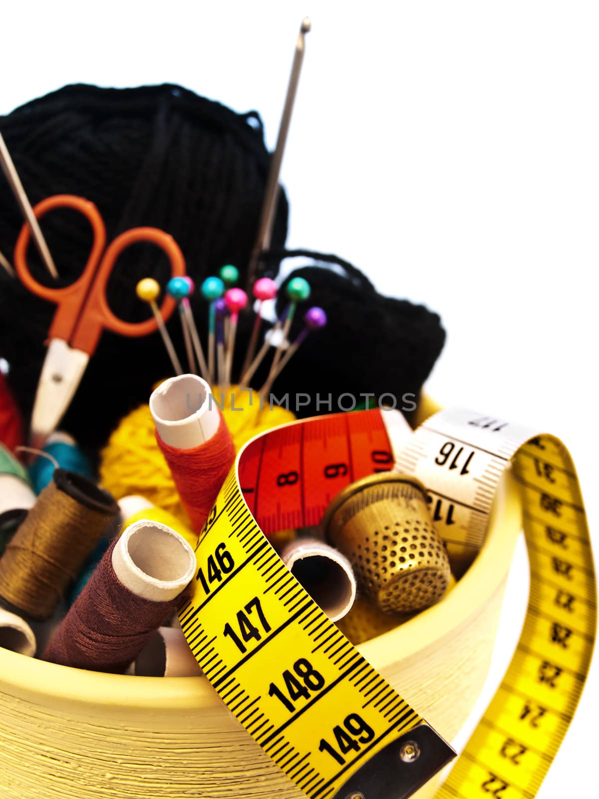 different knitting items in the pot over the white background