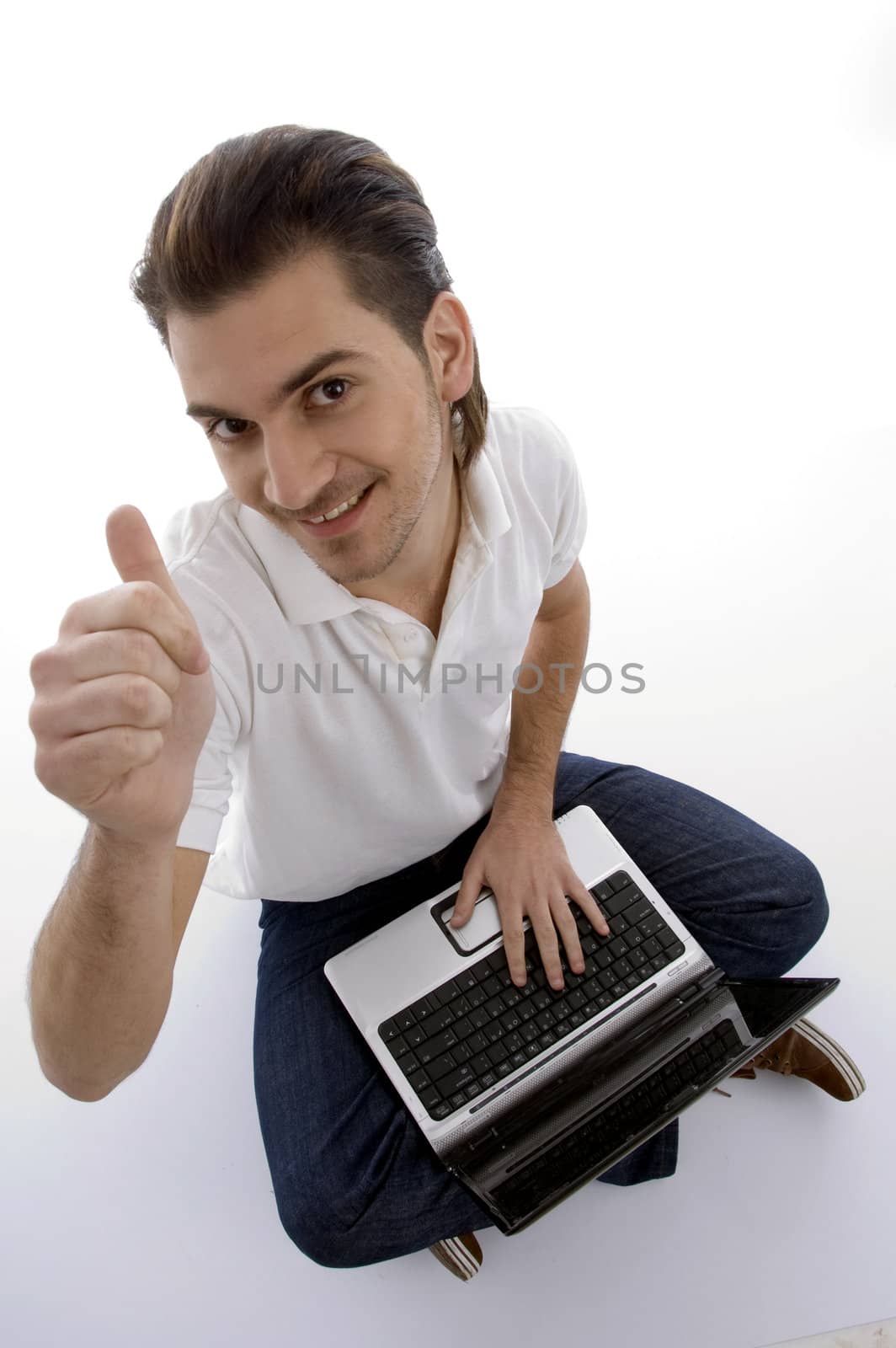 young man sitting with laptop on an isolated white backgound