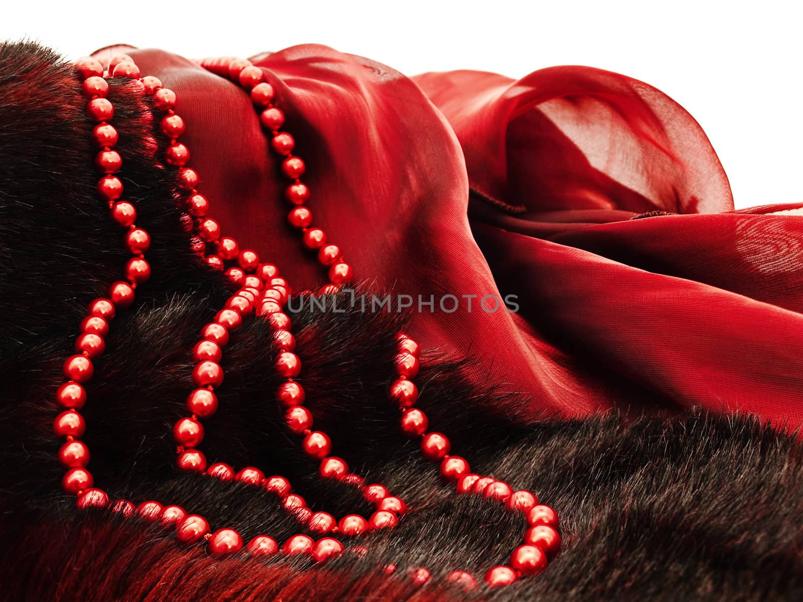  fashion red necklace in chaplet shape over burgundy textile and fur  background