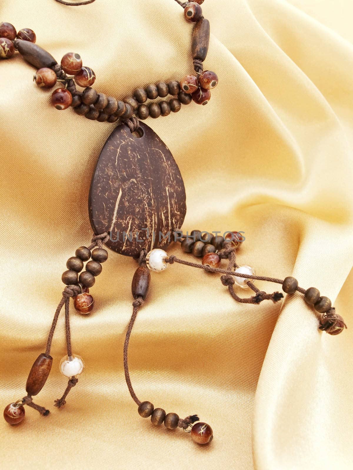  fashion wooden handmade necklace  over golden textile background
