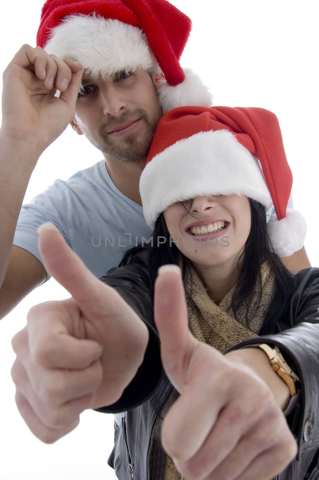 young couple with chritsmas hat  by imagerymajestic