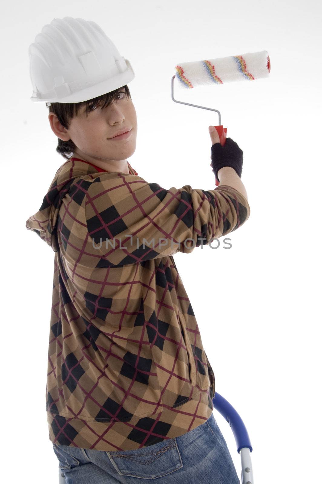 smiling young architect with paint brush on an isolated background