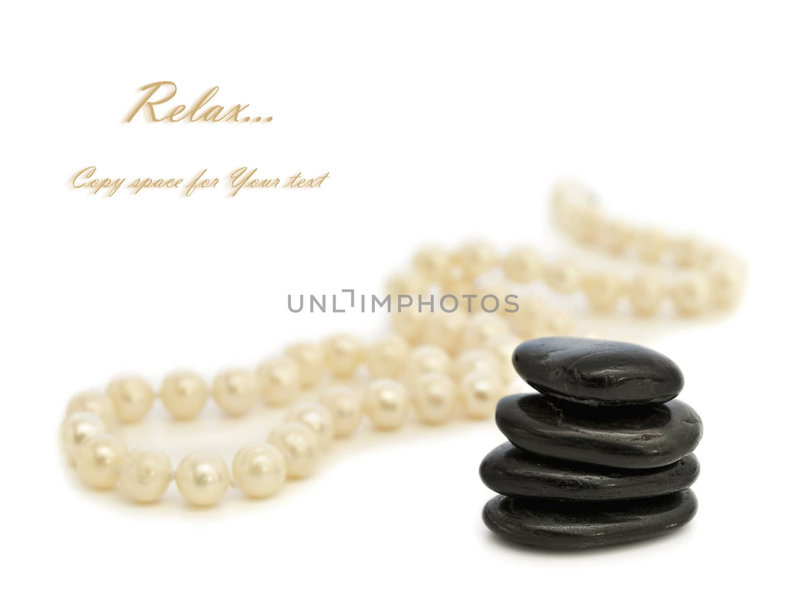 Relax theme with pearl beads and Zen stones over white background