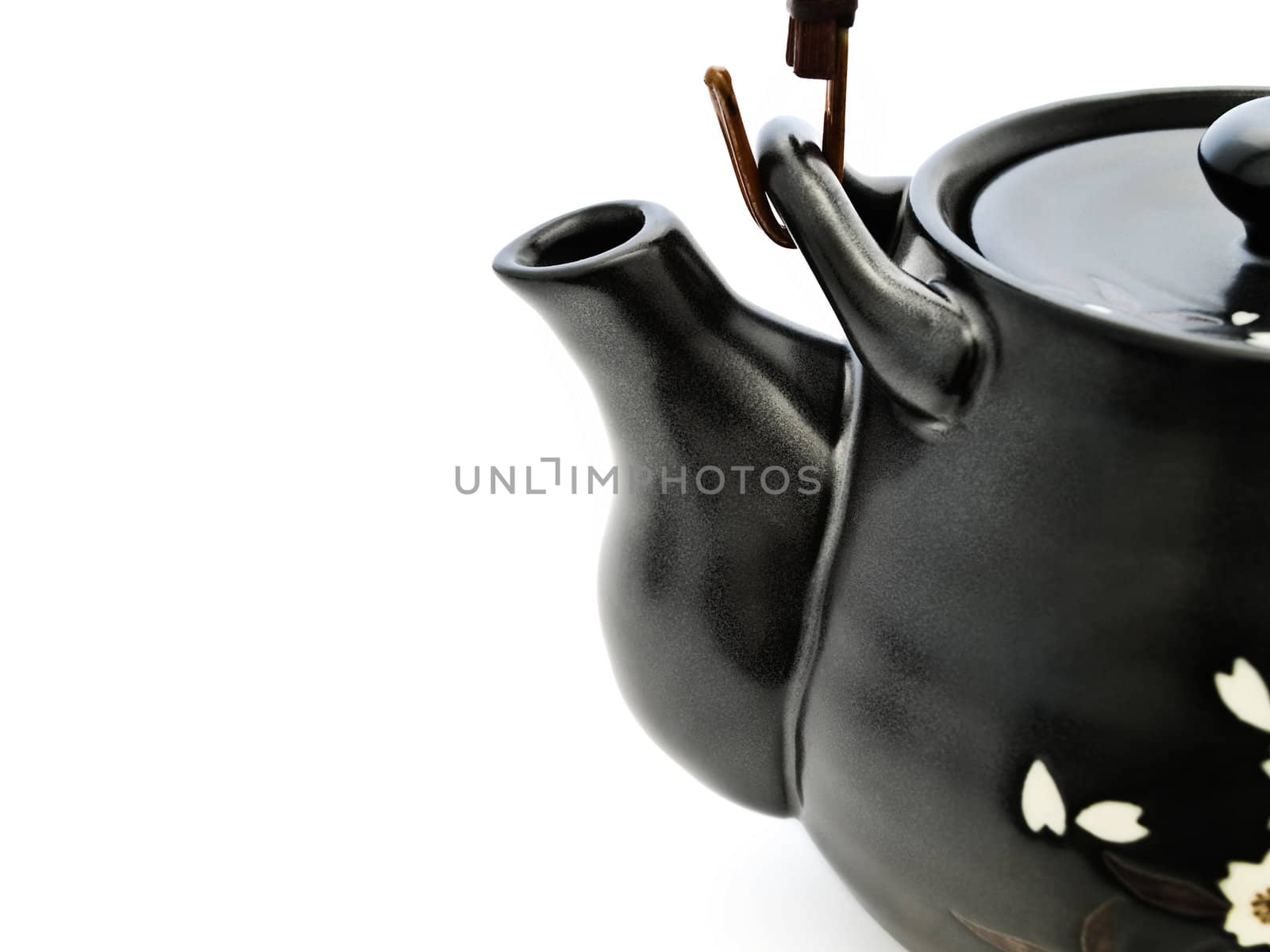 half of black china teapot for chinese tea ceremony with copyspace over white 