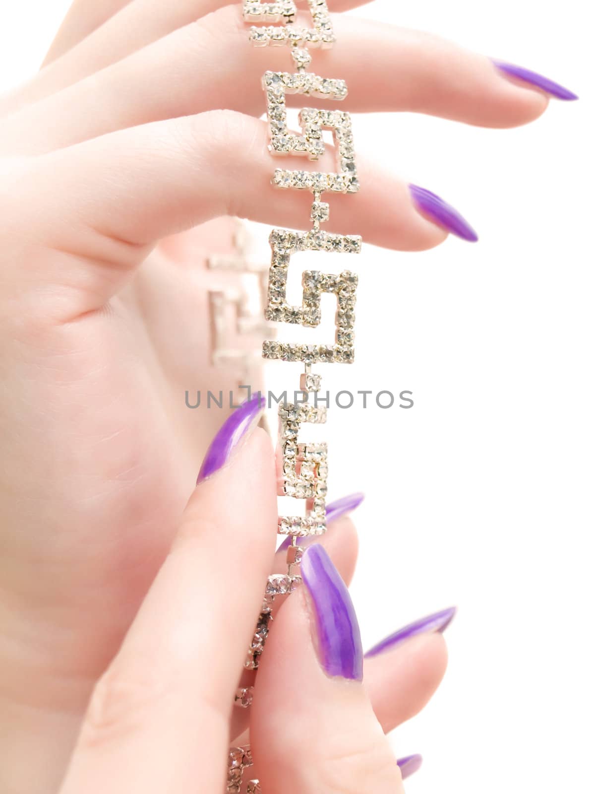 jewelry in woman hands with lilac manicure