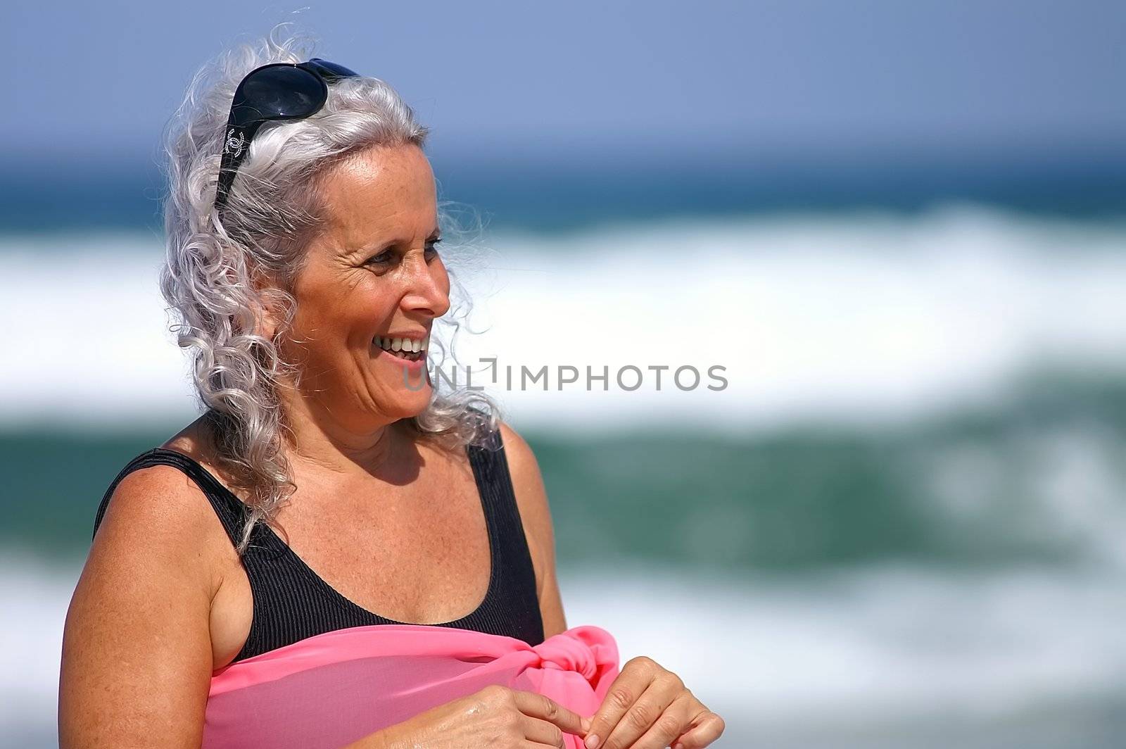 an elder happy woman at the beach