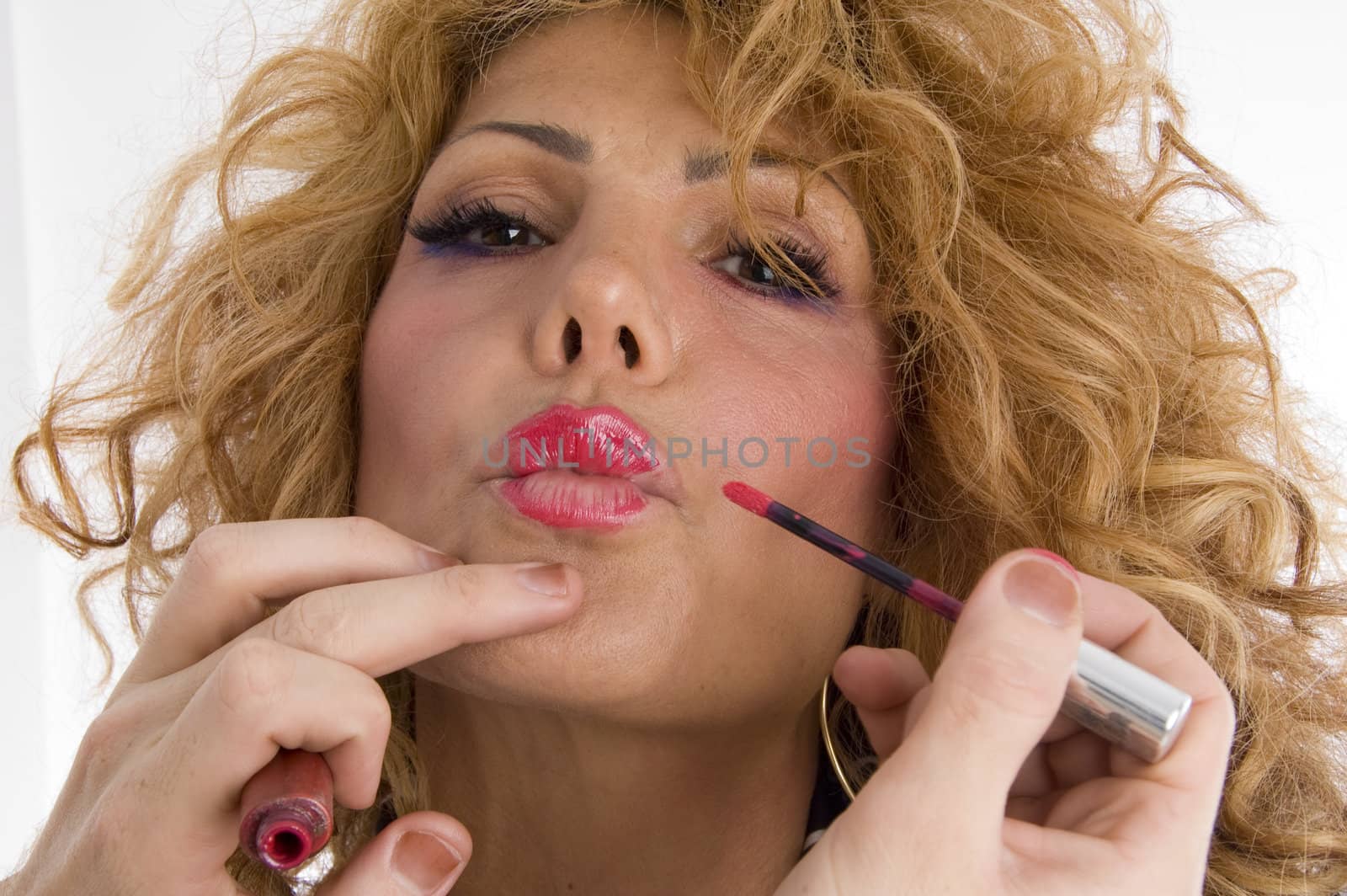 beautician doing lip make up of woman on an isolated background