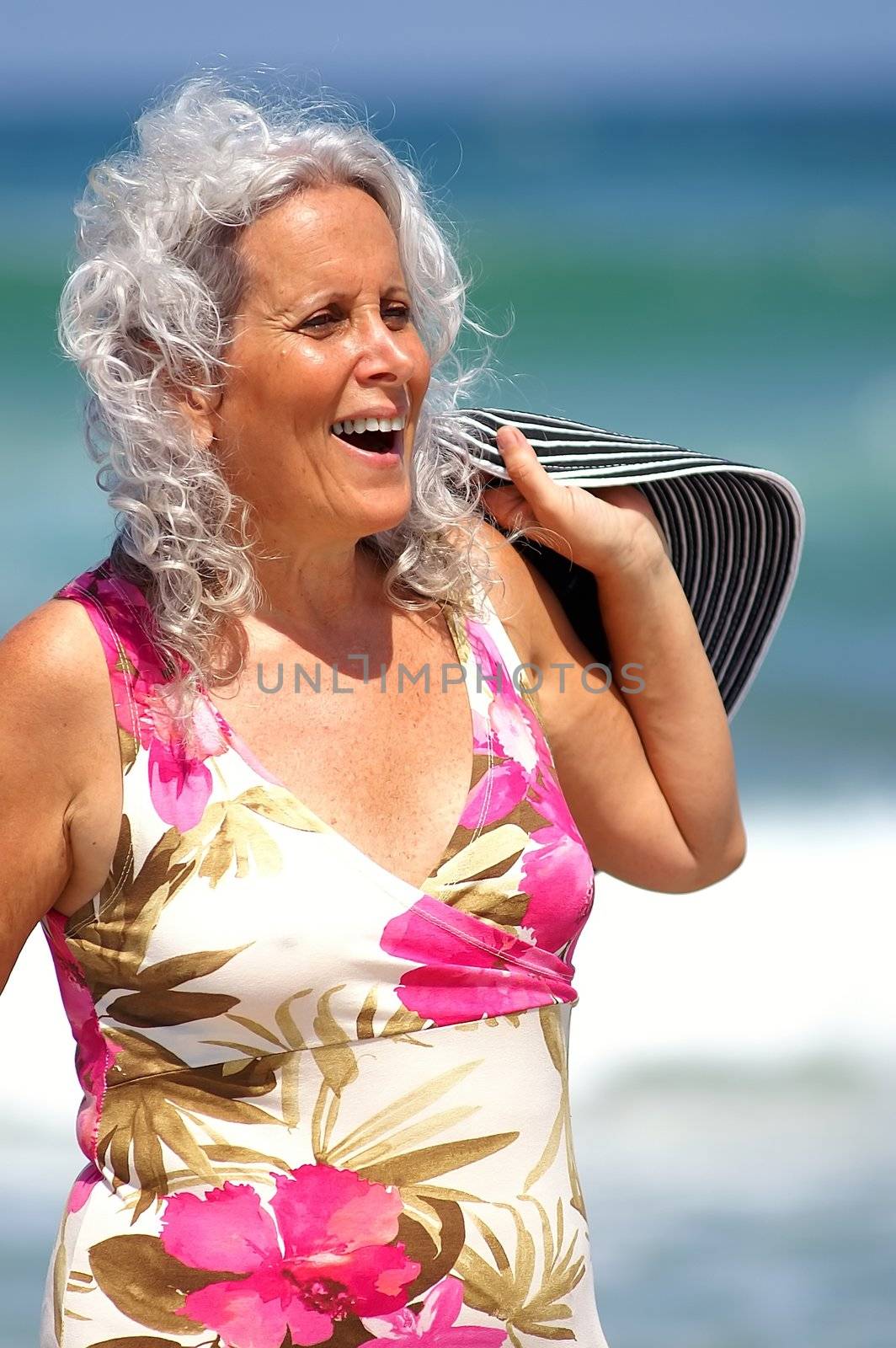 a happy elder woman at the beach