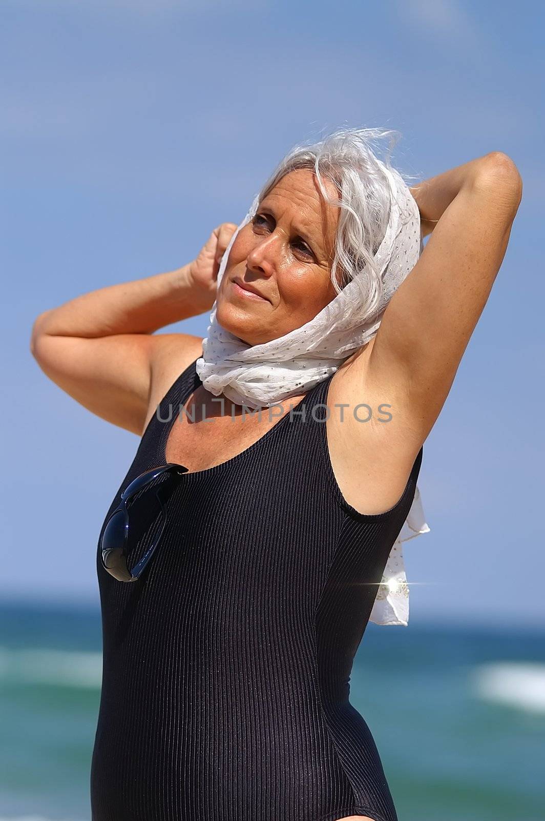 an elder woman relaxing at the beach