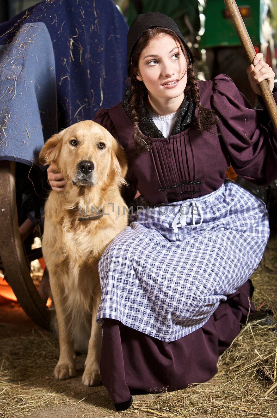 Beautiful girl in traditional farmers clothing with her dog