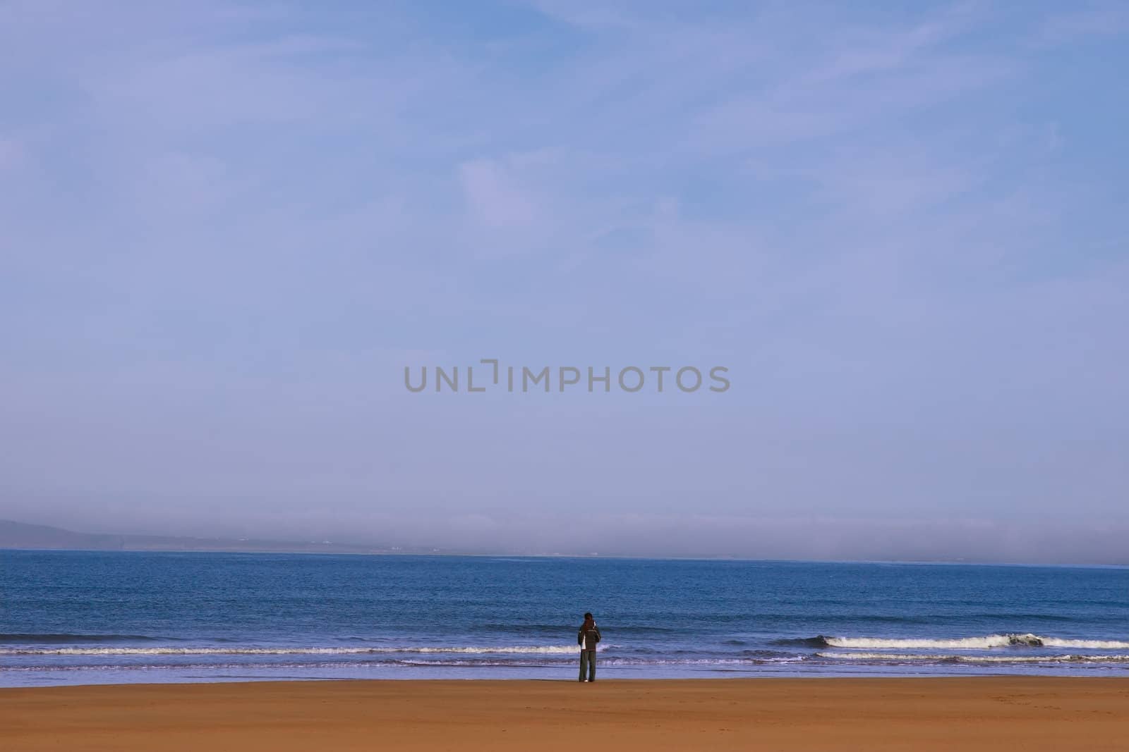 woman on the shoreline lost in thought